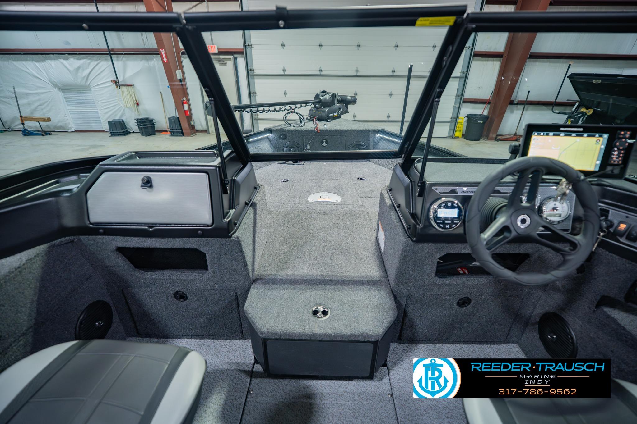 Interior view of 2026 Lund 1775 Impact XS boat with steering wheel and dashboard.