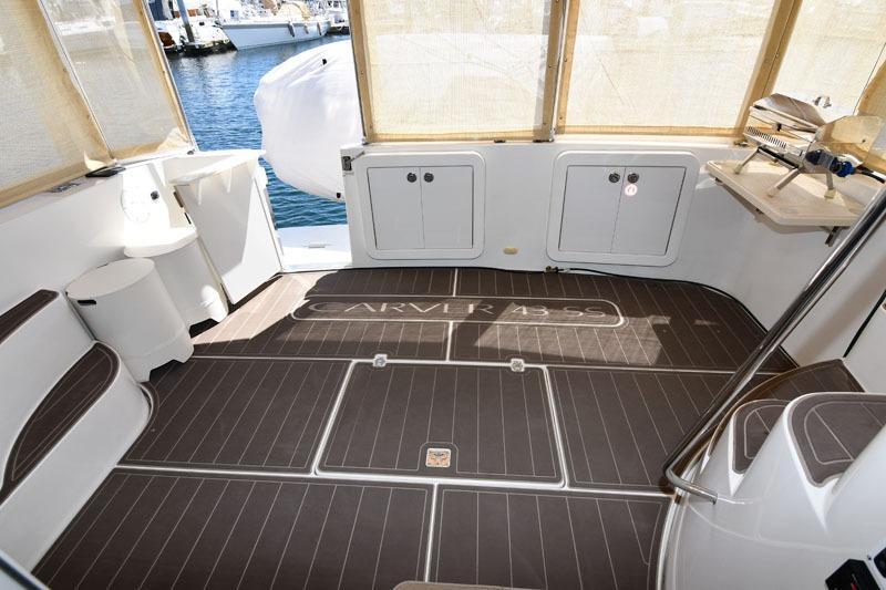 2008 Carver 43 Super Sport yacht interior with seating, storage, and wood flooring.