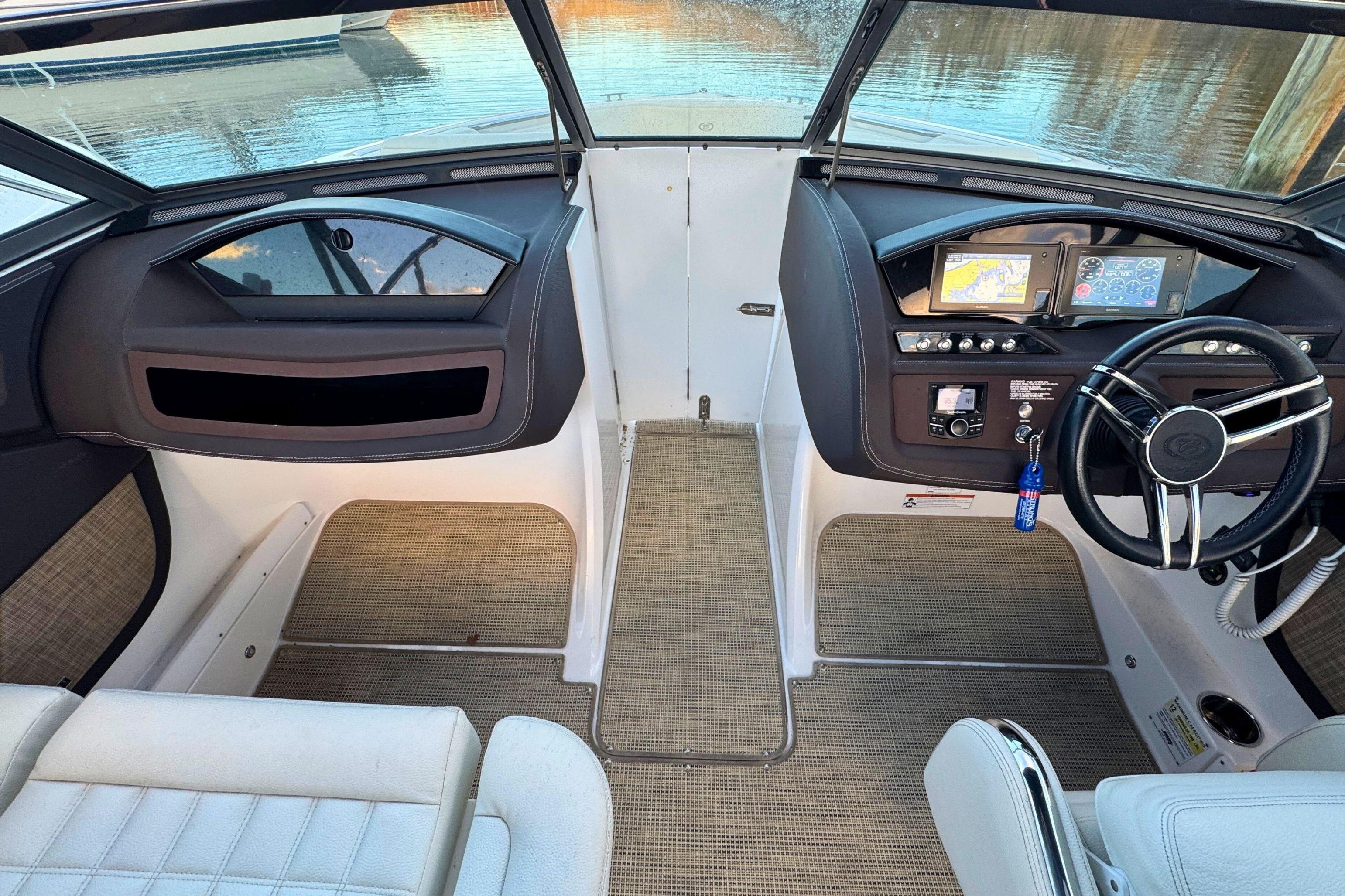 2019 Cobalt R3 boat interior with modern dashboard and steering wheel, overlooking water.