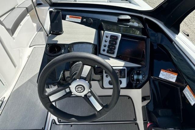 2026 Yamaha Boats AR220 dashboard with steering wheel, control panel, and modern navigation system.