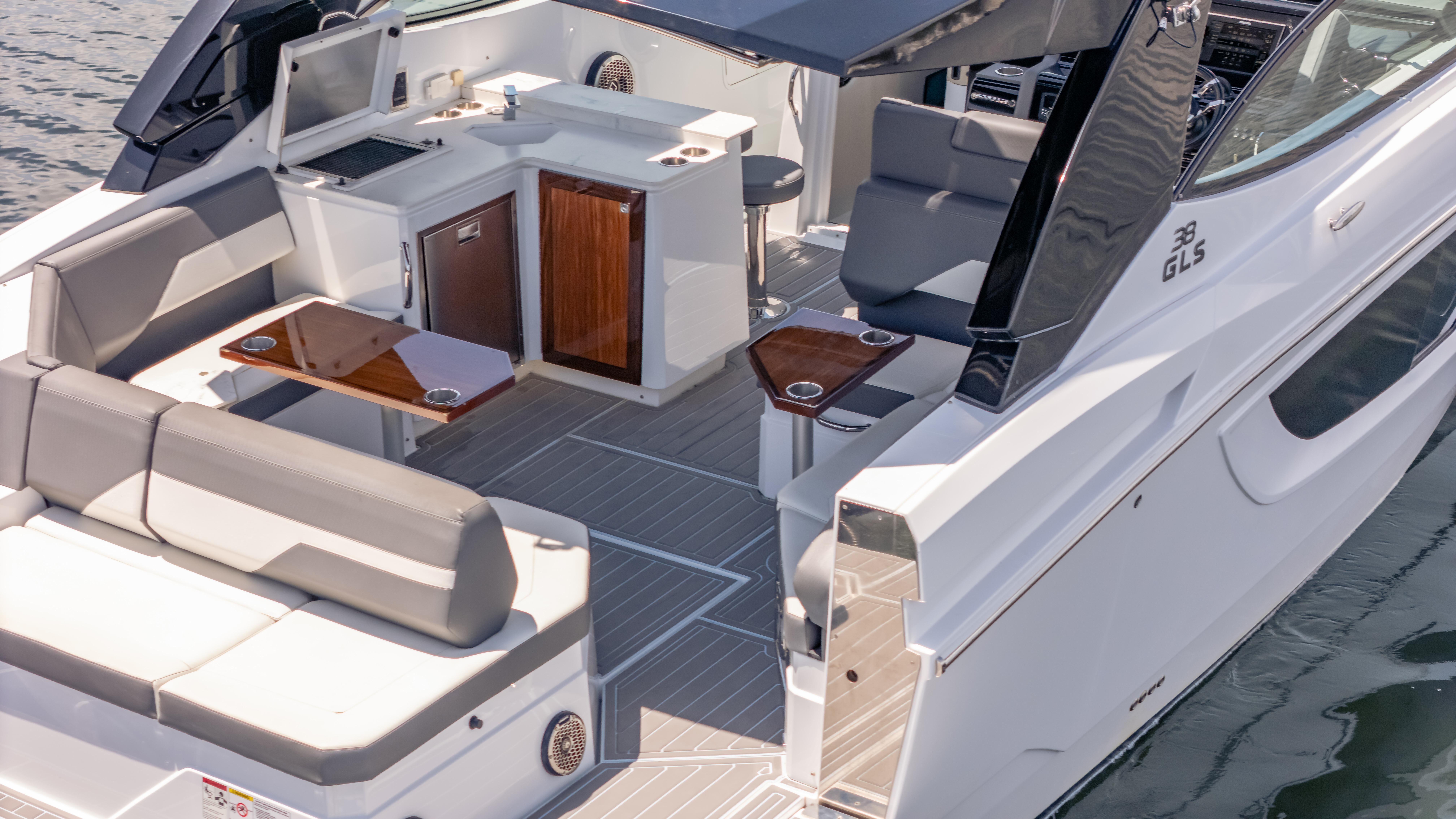 2021 Cruisers Yachts 38 GLS luxury boat interior with seating and kitchenette.