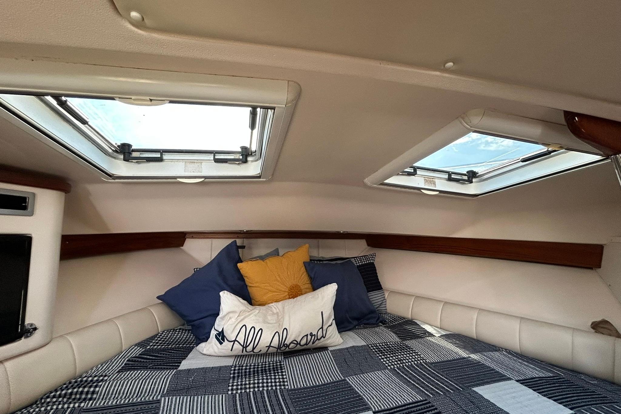 2007 Grady-White Express 360 cabin interior with skylights and cozy bedding.