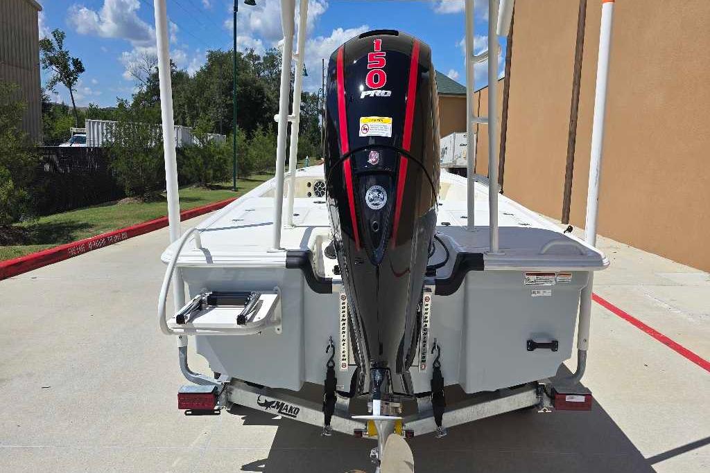 2026 Mako 18 Pro Skiff with 150 Pro outboard motor, parked outdoors.