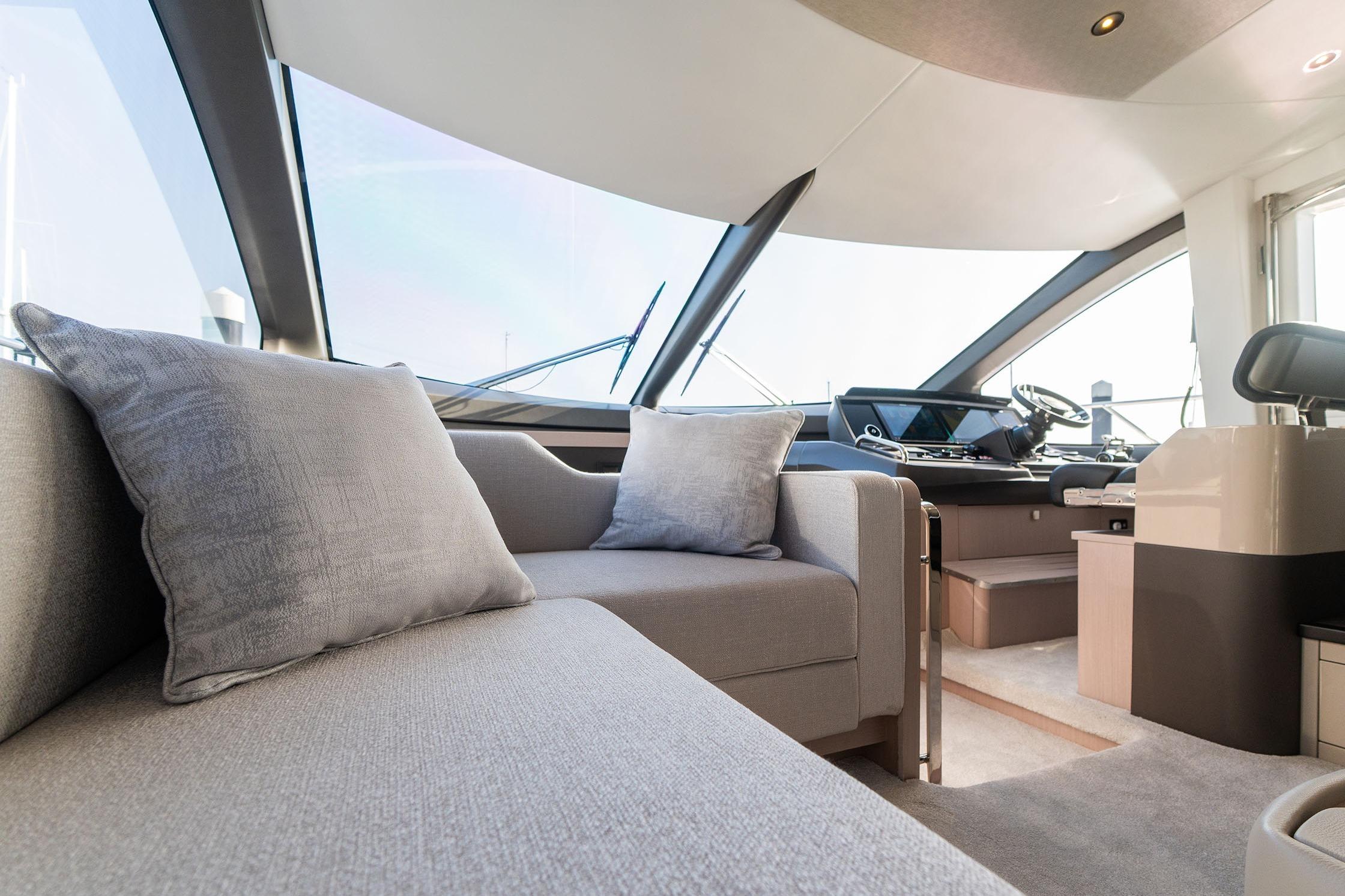 Luxurious interior of 2026 Sunseeker Manhattan 68 yacht with modern seating and helm.