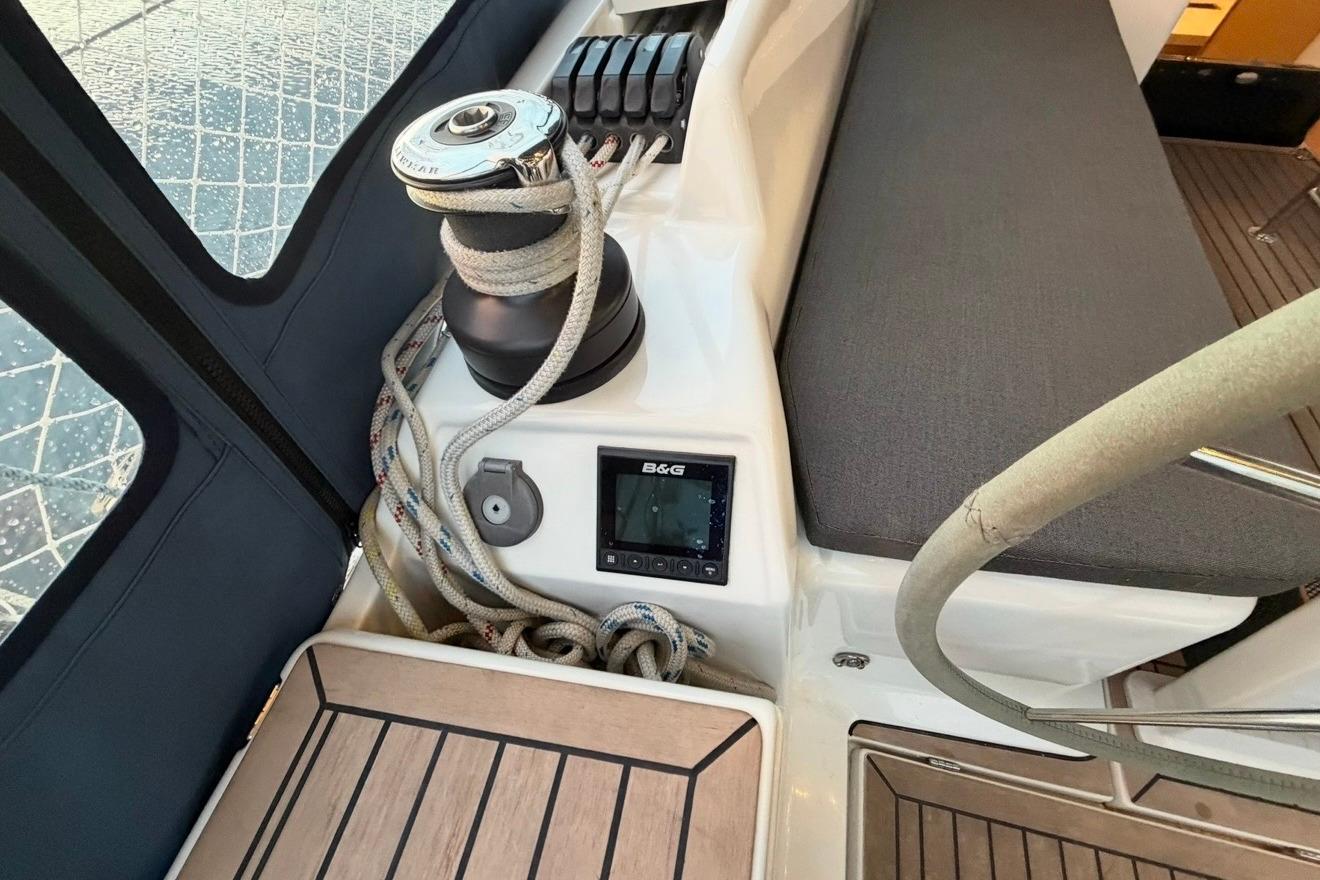Cockpit of 2022 Hanse 418 yacht with winch, ropes, and B&G navigation display.