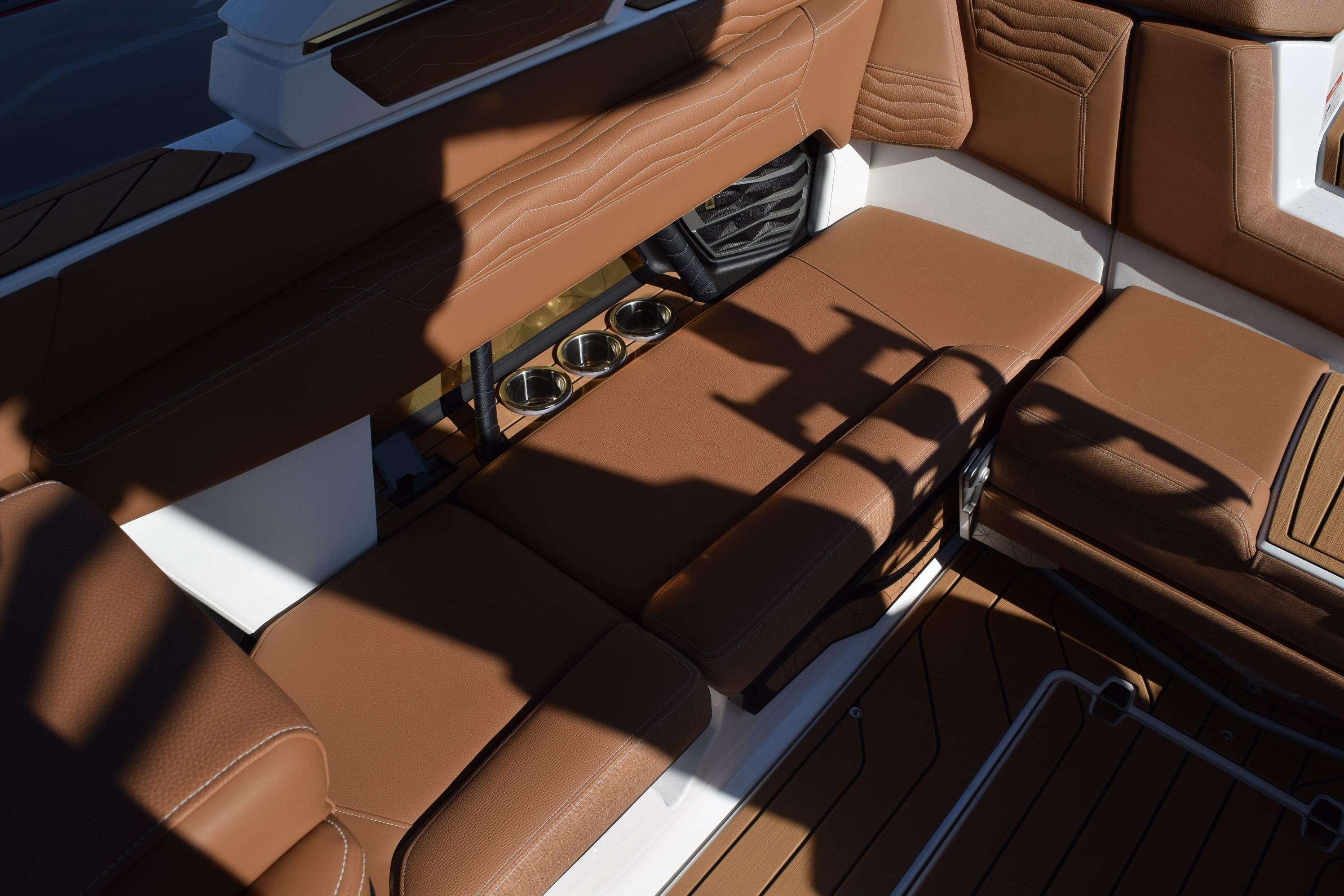 2026 Nautique Super Air Nautique G23 interior with brown leather seating and cup holders.