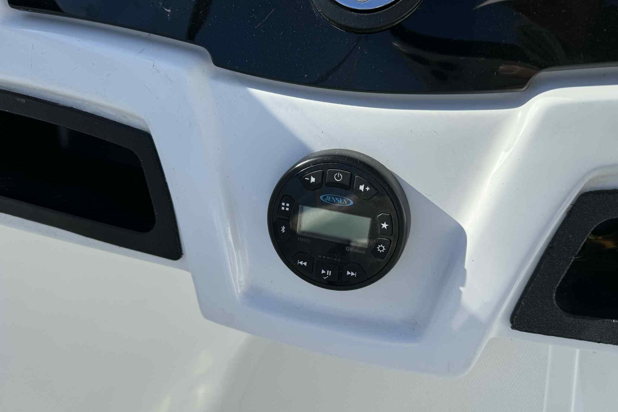 Control panel of a 2021 Tahoe 550 TS boat featuring a Jensen audio system.