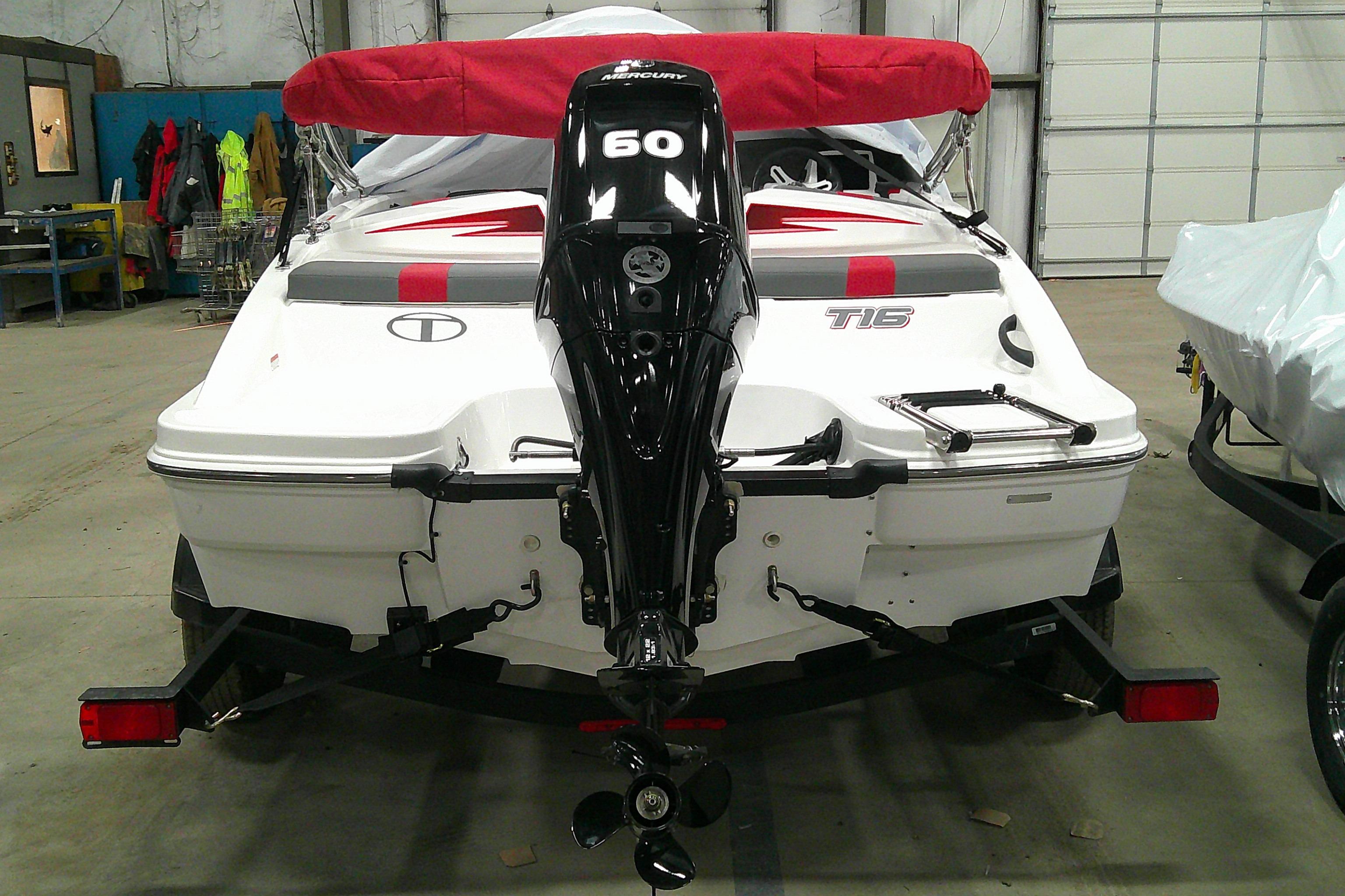 2024 Tahoe T16 boat with outboard motor in a garage setting.