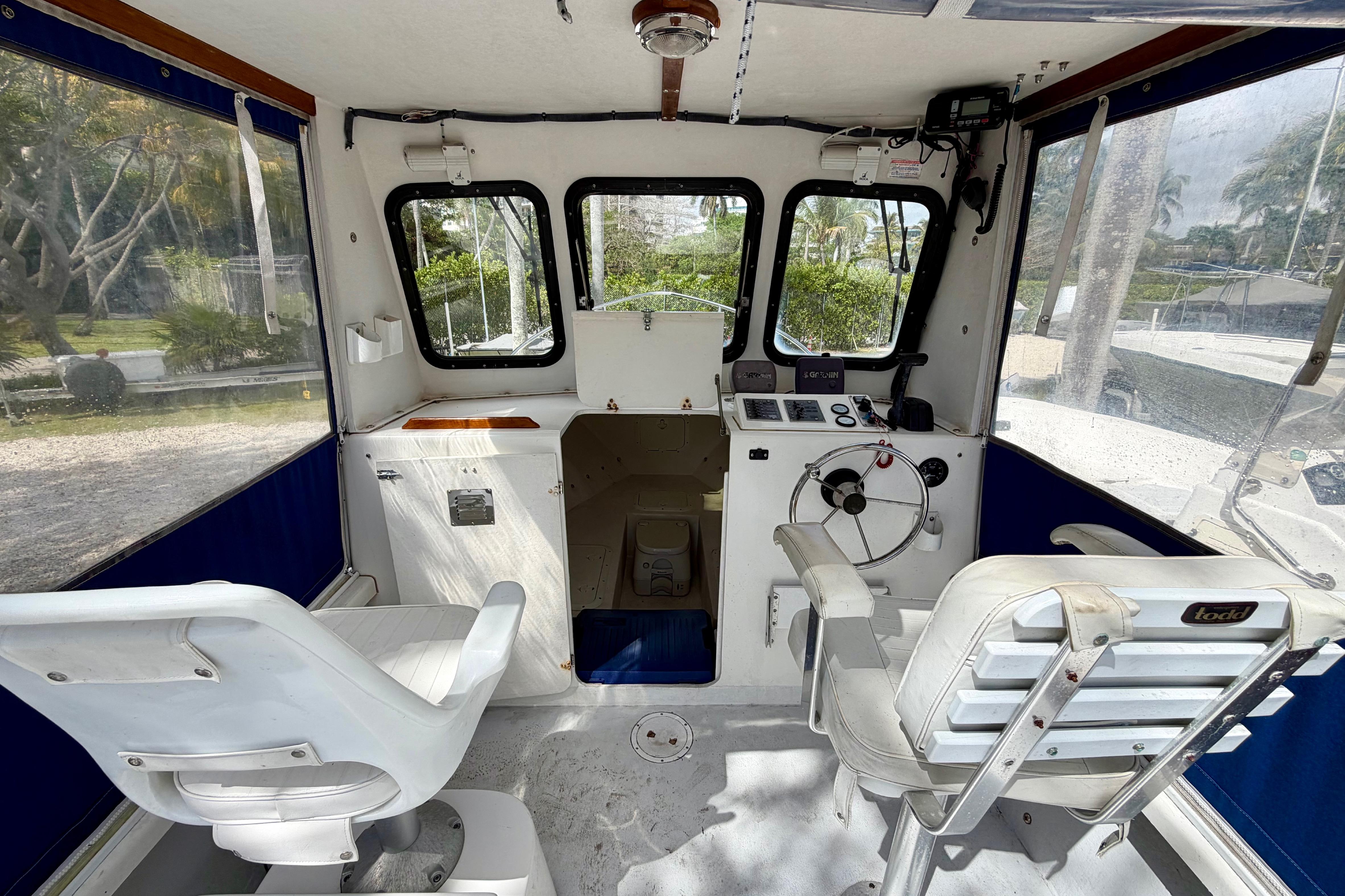 Interior of 2000 Eastern 22 Lobster Fisherman boat with steering wheel and seating.