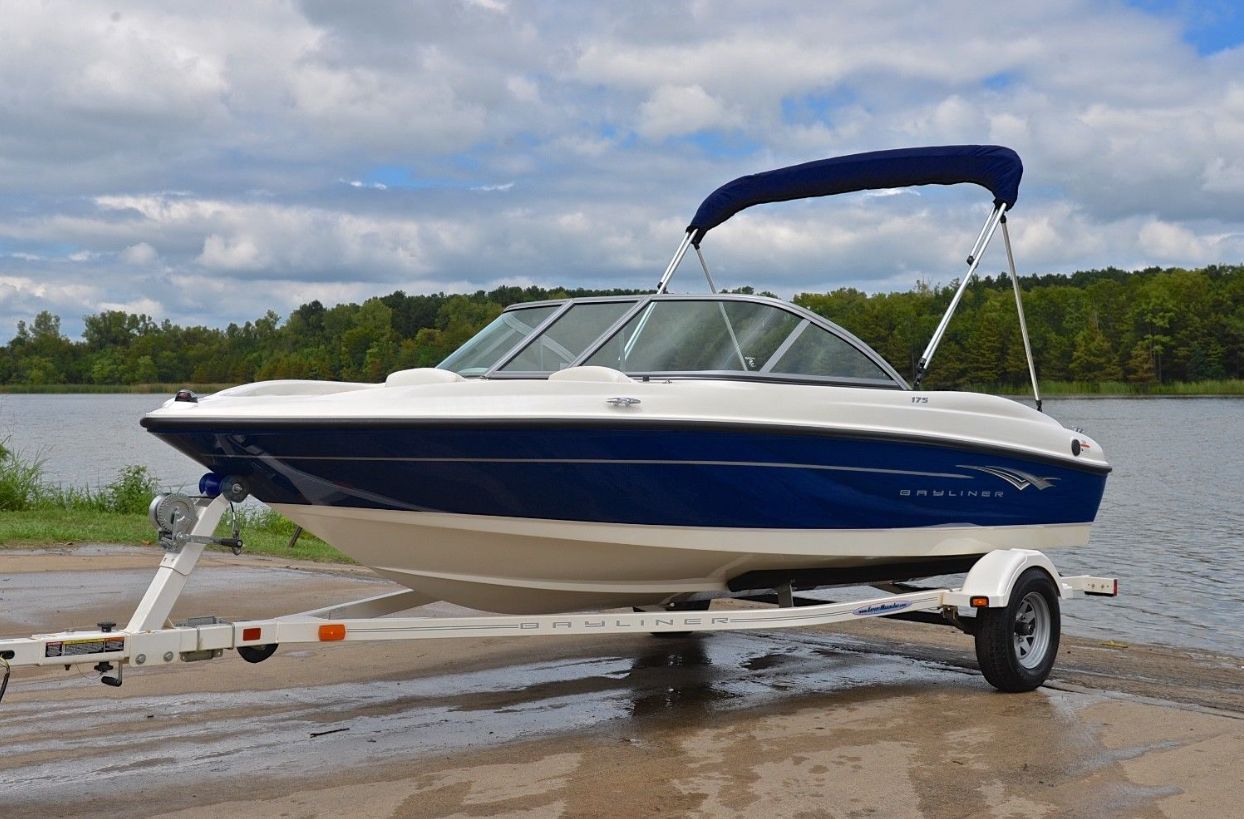 A 2010 Bayliner 175 Bowrider on a trailer by a lakeside.