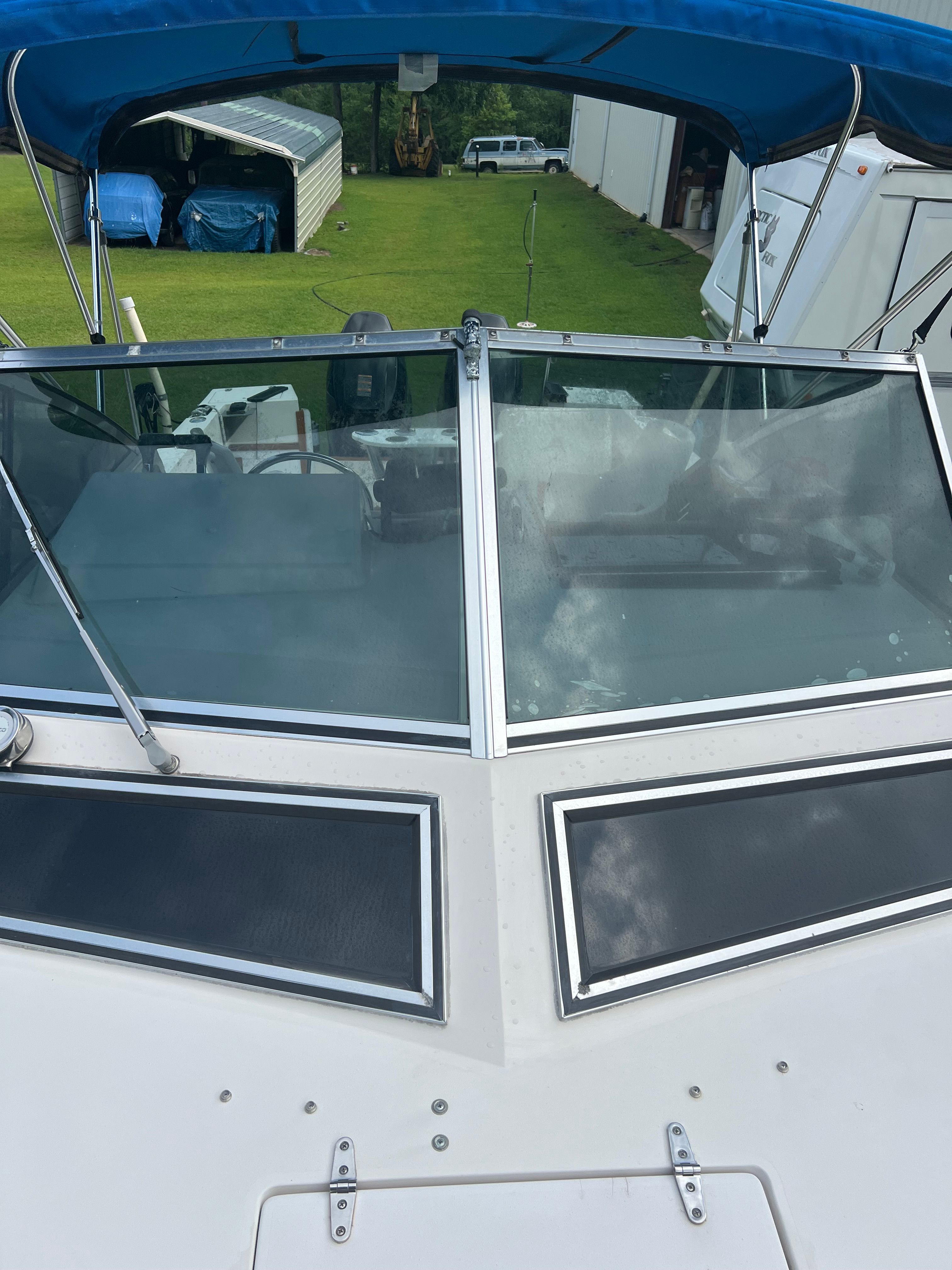 1987 Grady-White Gulfstream boat with blue canopy and windshield.