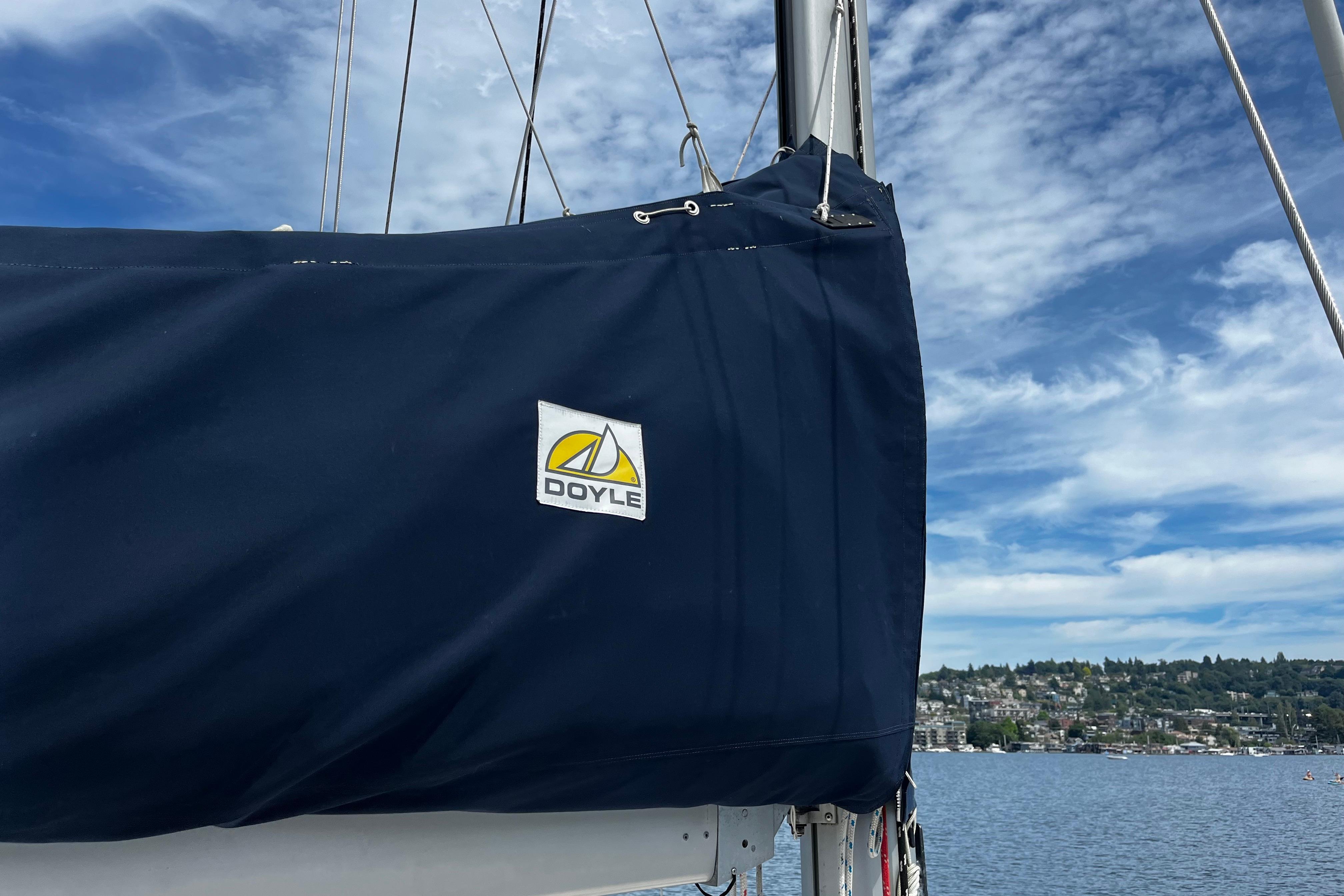 Sailboat with Doyle sail cover on a Hanse 411, 2004 model, under a blue sky.