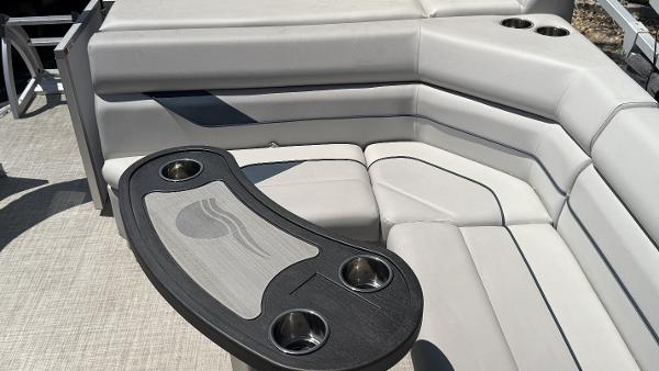 2023 SunCatcher Select 322FC boat interior with gray seating and cup holders.