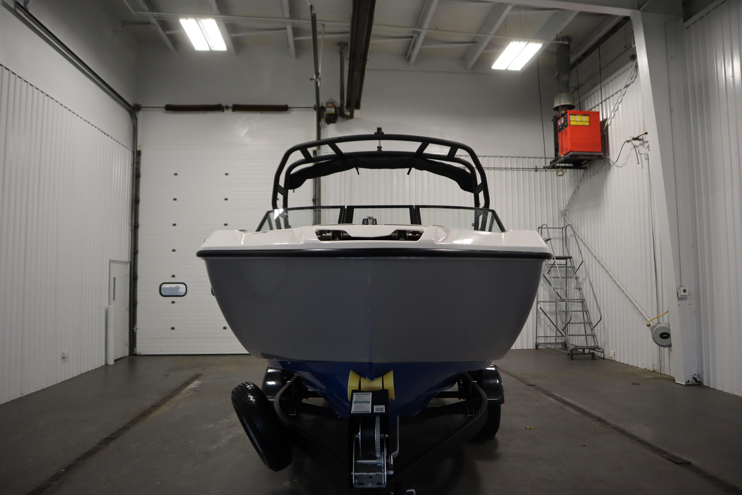 2026 Yamaha Boats AR220 in a garage, front view, showcasing sleek design.