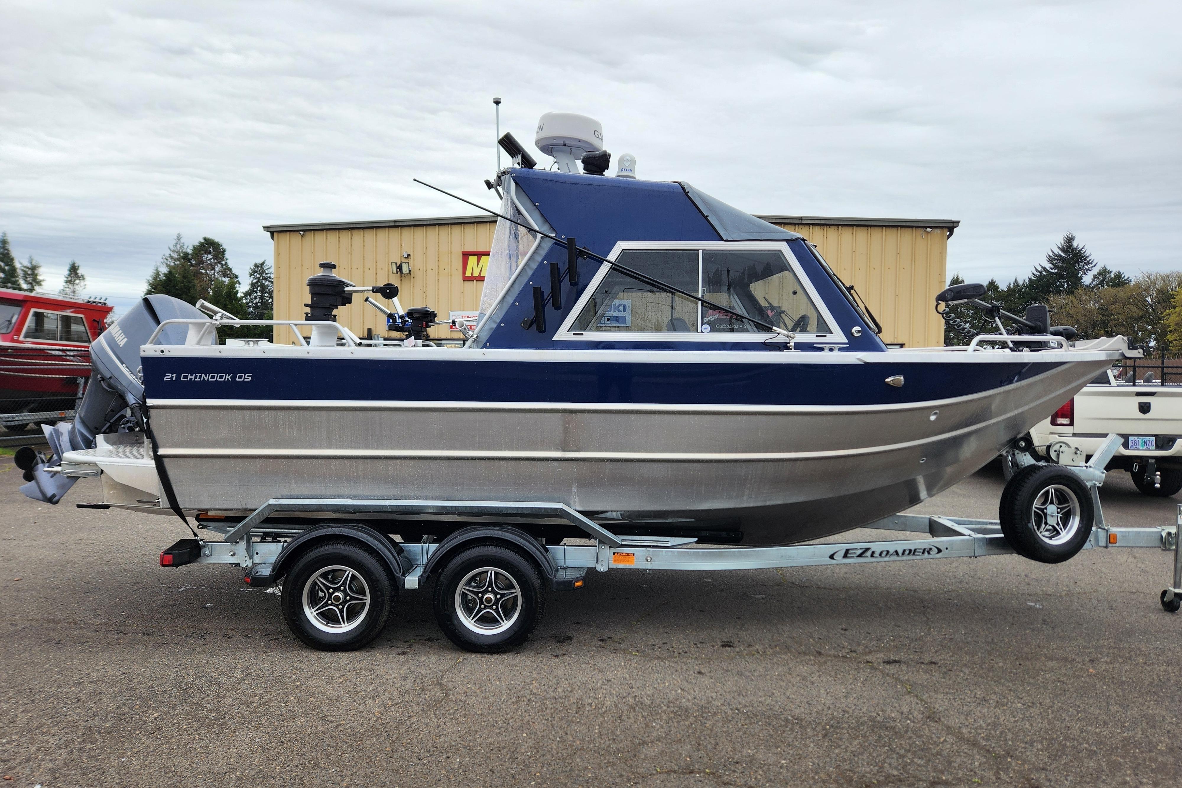 2025 Thunder Jet 21 Chinook OS boat on trailer, parked outdoors.