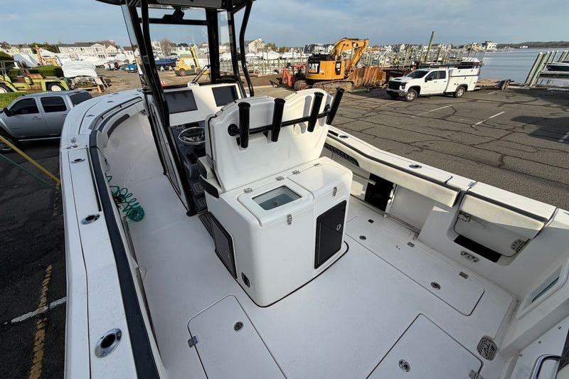 2023 Tidewater 282 CC Adventure Bluewater boat docked, showcasing spacious deck and seating.