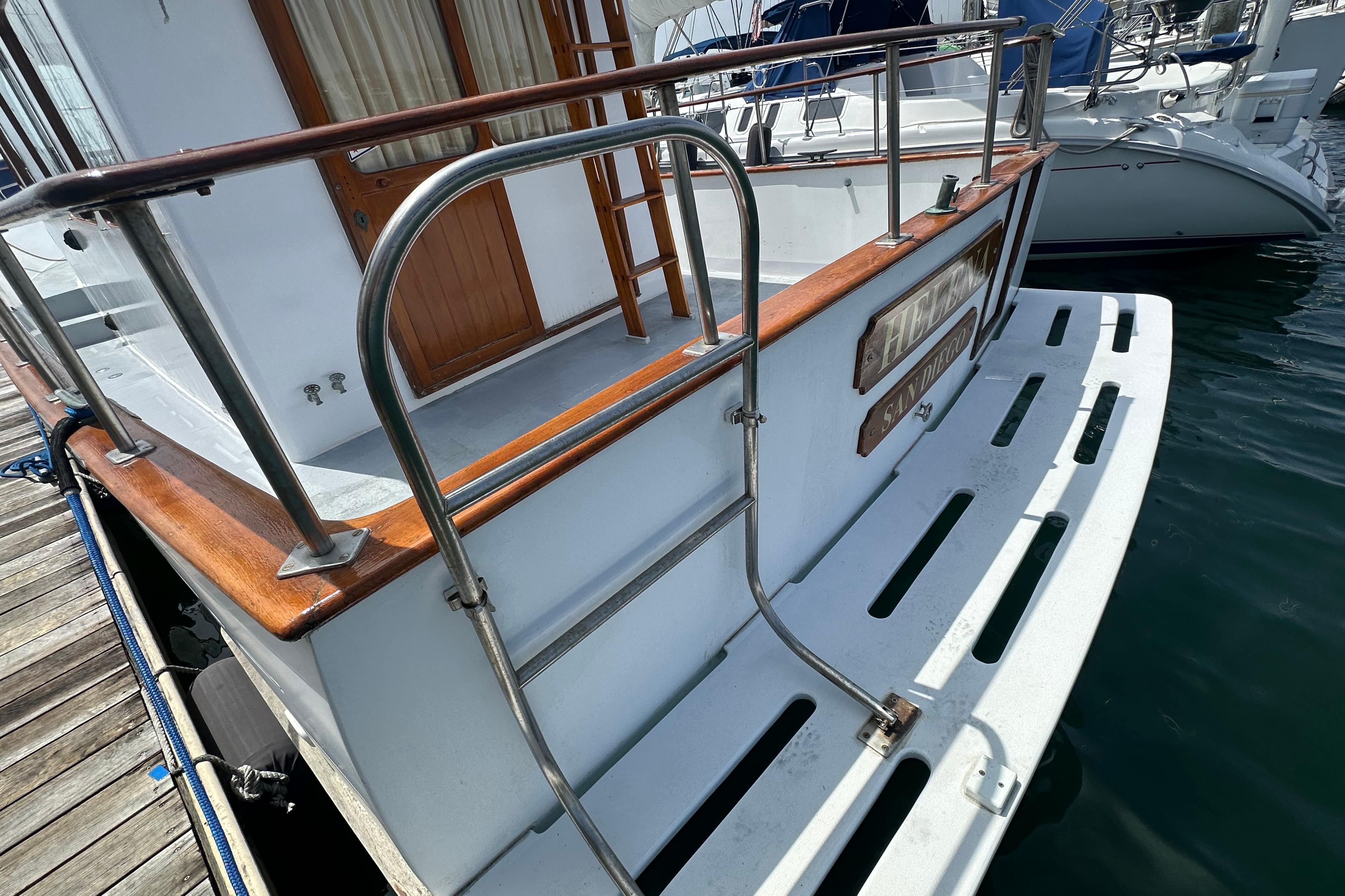 1973 CHB 33 boat stern with wooden railings and swim platform at marina.
