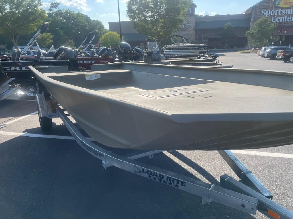 2025 Tracker GRIZZLY 2072 Utility boat on Load Rite trailer in parking lot.