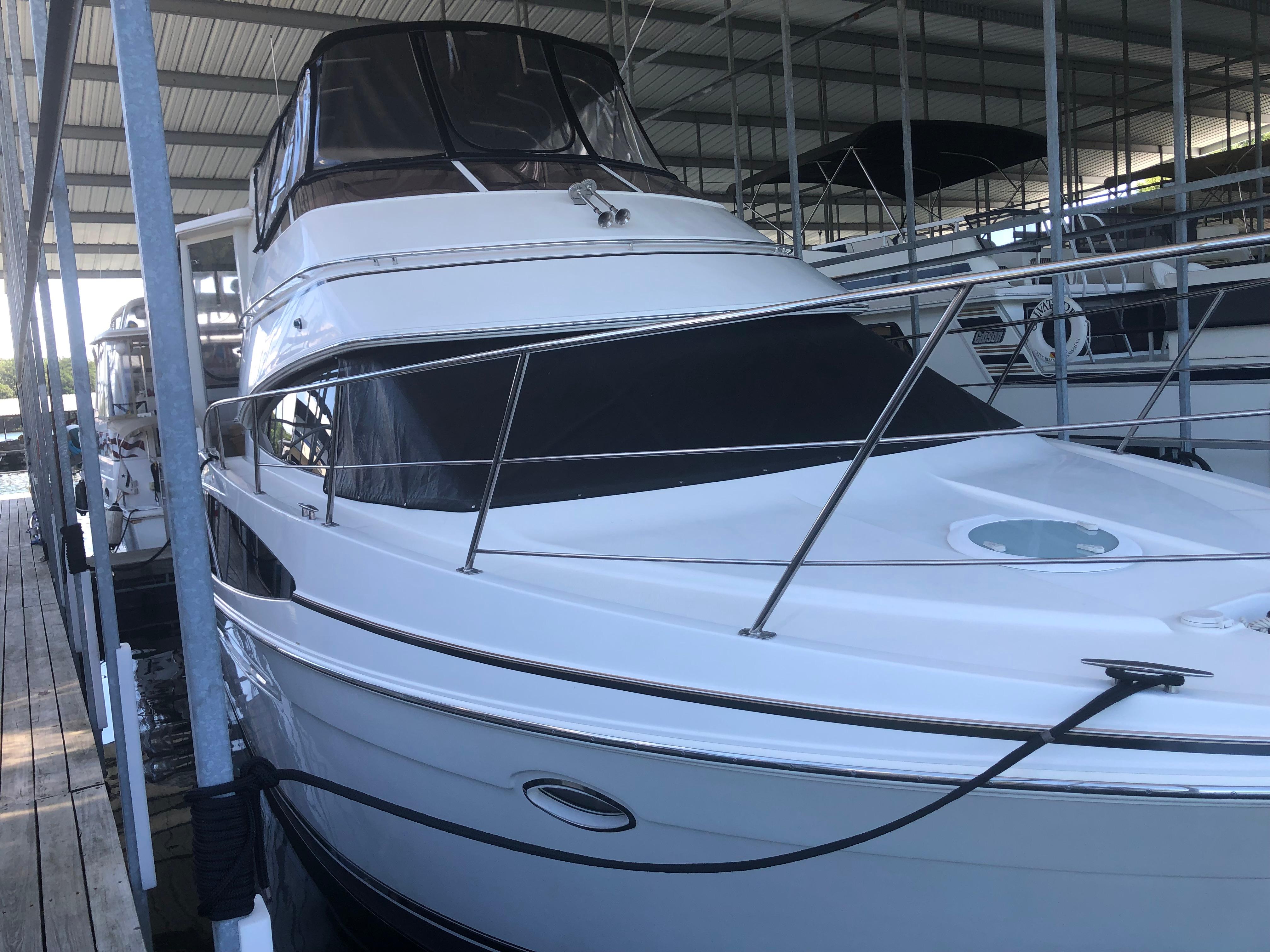2005 Carver 41 Cockpit Motor Yacht docked in a covered marina.