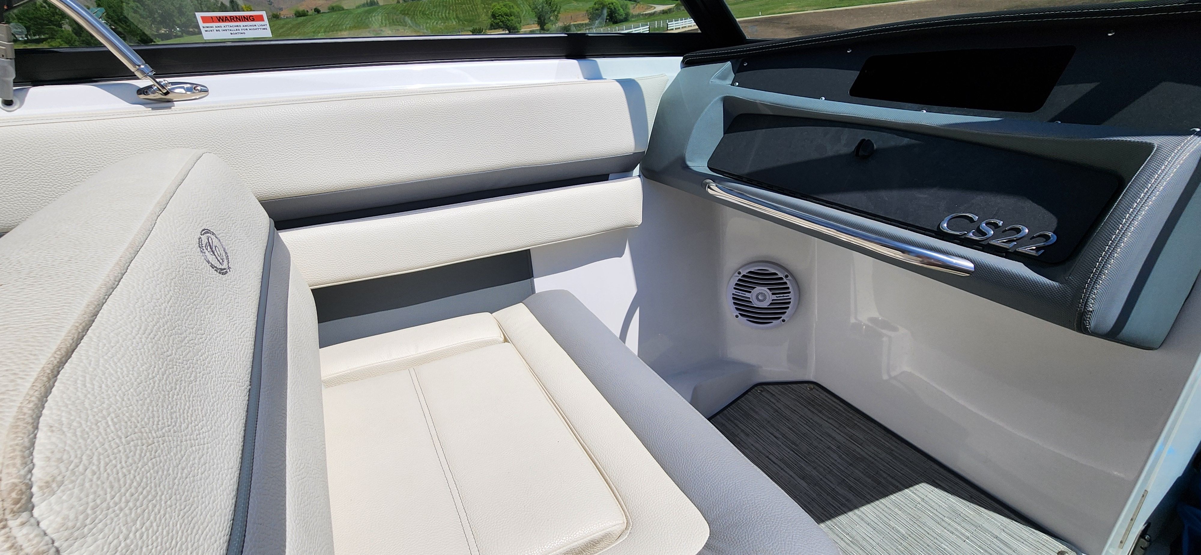Interior of a Cobalt CS22 boat with white seating and gray flooring.