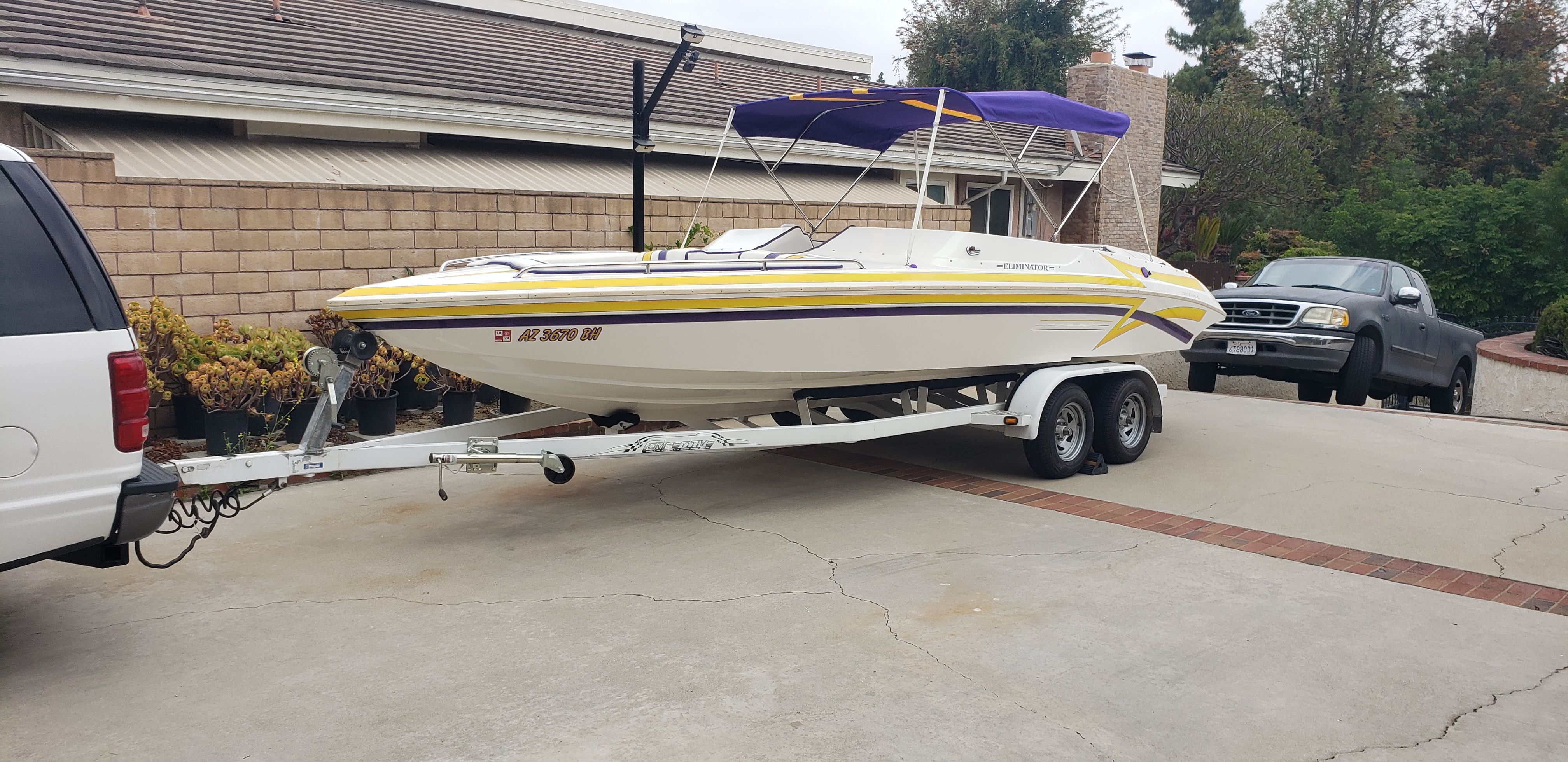 1999 Eliminator 220 Eagle XP boat on trailer in driveway.