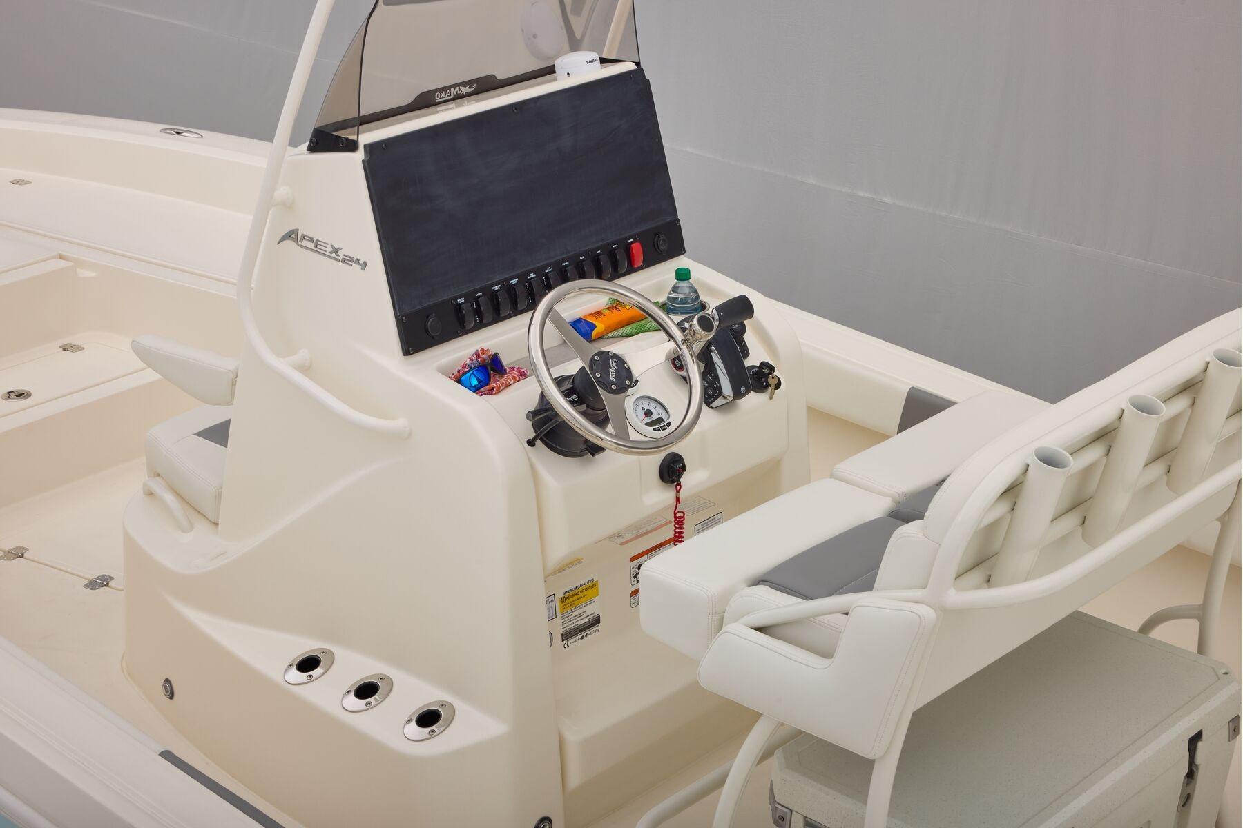2026 Mako 24 APEX boat console with steering wheel and seating.