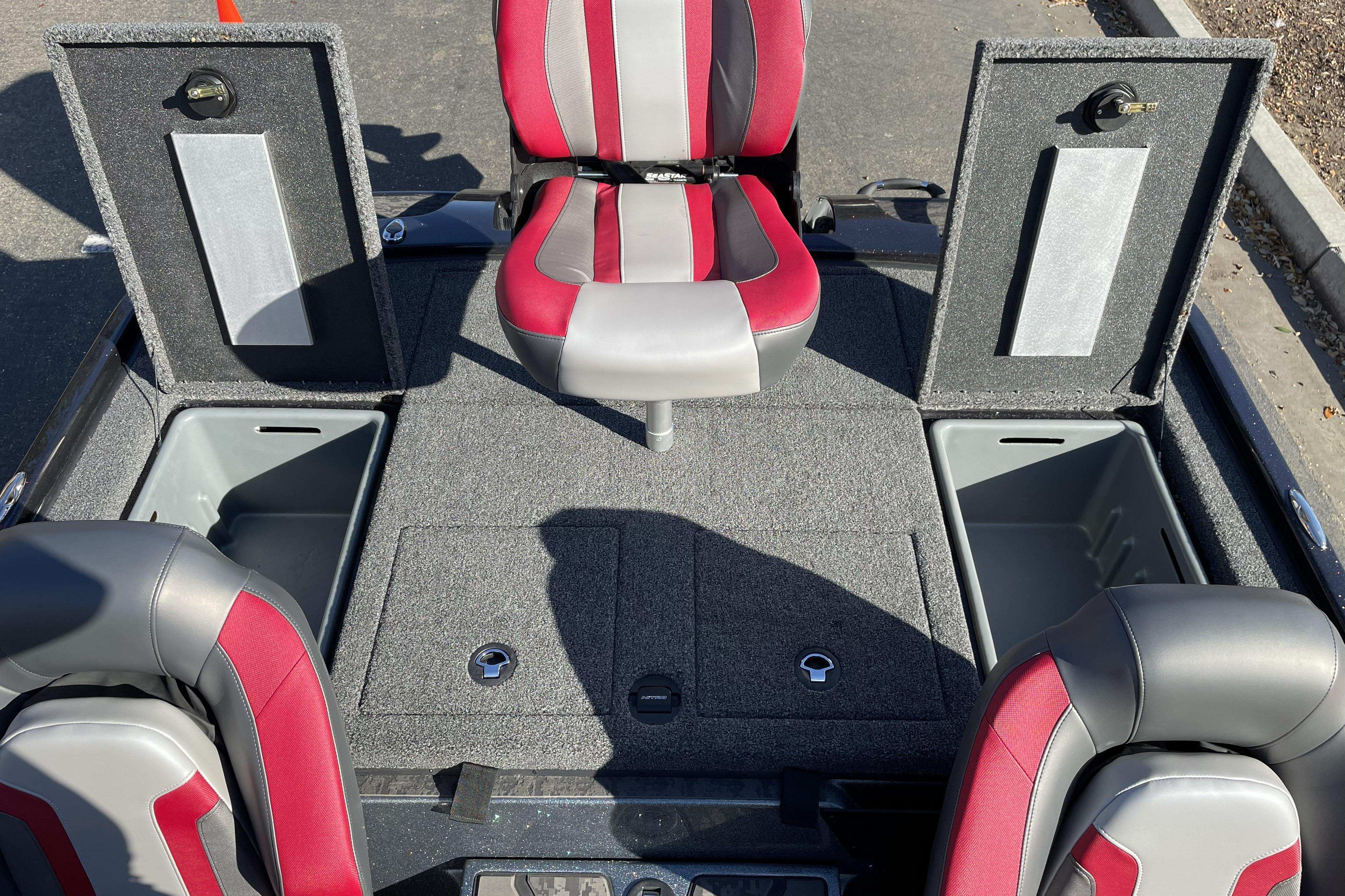 2026 Nitro Z20 XL boat interior with red and gray seating, storage compartments open.