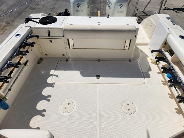 2005 Pursuit 3070 Offshore Center Console boat deck with rod holders and storage compartments.