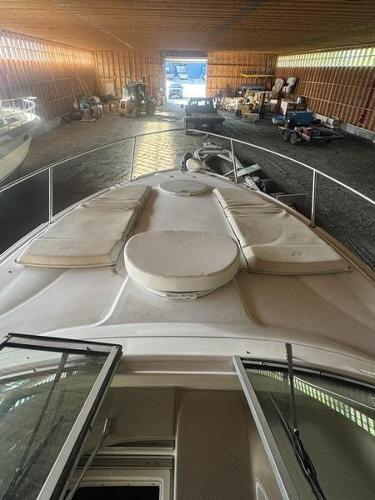 2005 Four Winns 298 Vista boat stored in a spacious indoor facility.