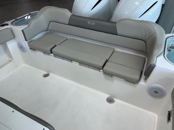 2024 Key West 263 FS boat with cushioned seating and storage compartments.