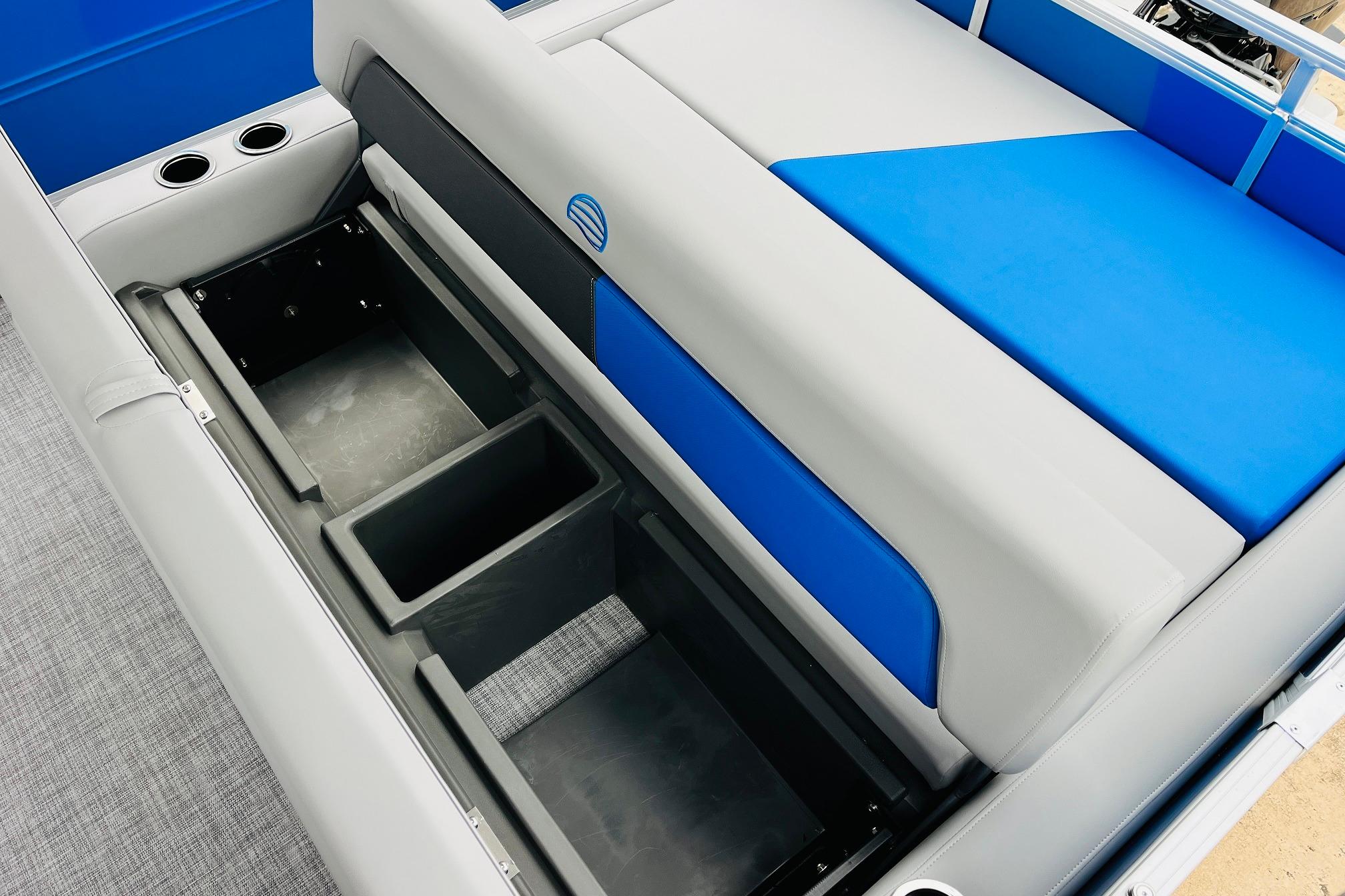 2026 Sun Tracker Party Barge 22 RF DLX boat seating with storage compartments.