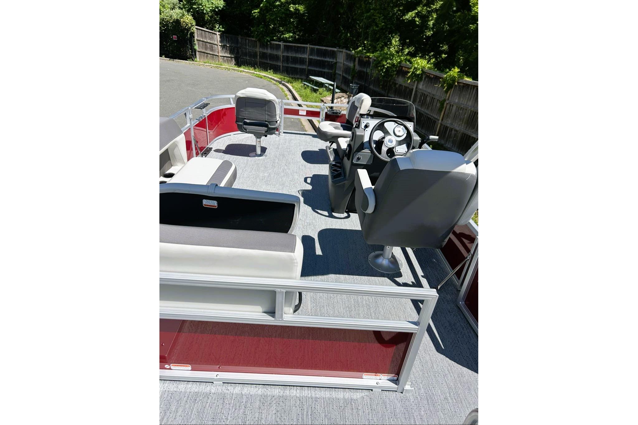 2026 Sun Tracker Bass Buggy 16 XL Select pontoon boat interior with seating and steering console.