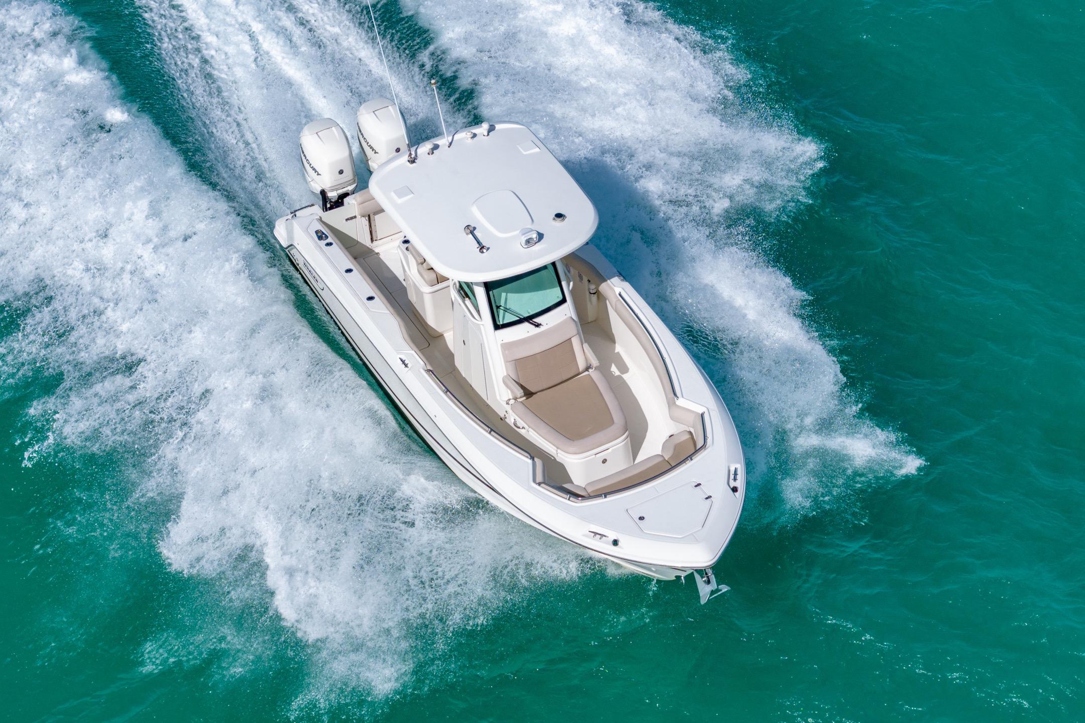 2016 Boston Whaler 280 Outrage cruising on turquoise water, aerial view.