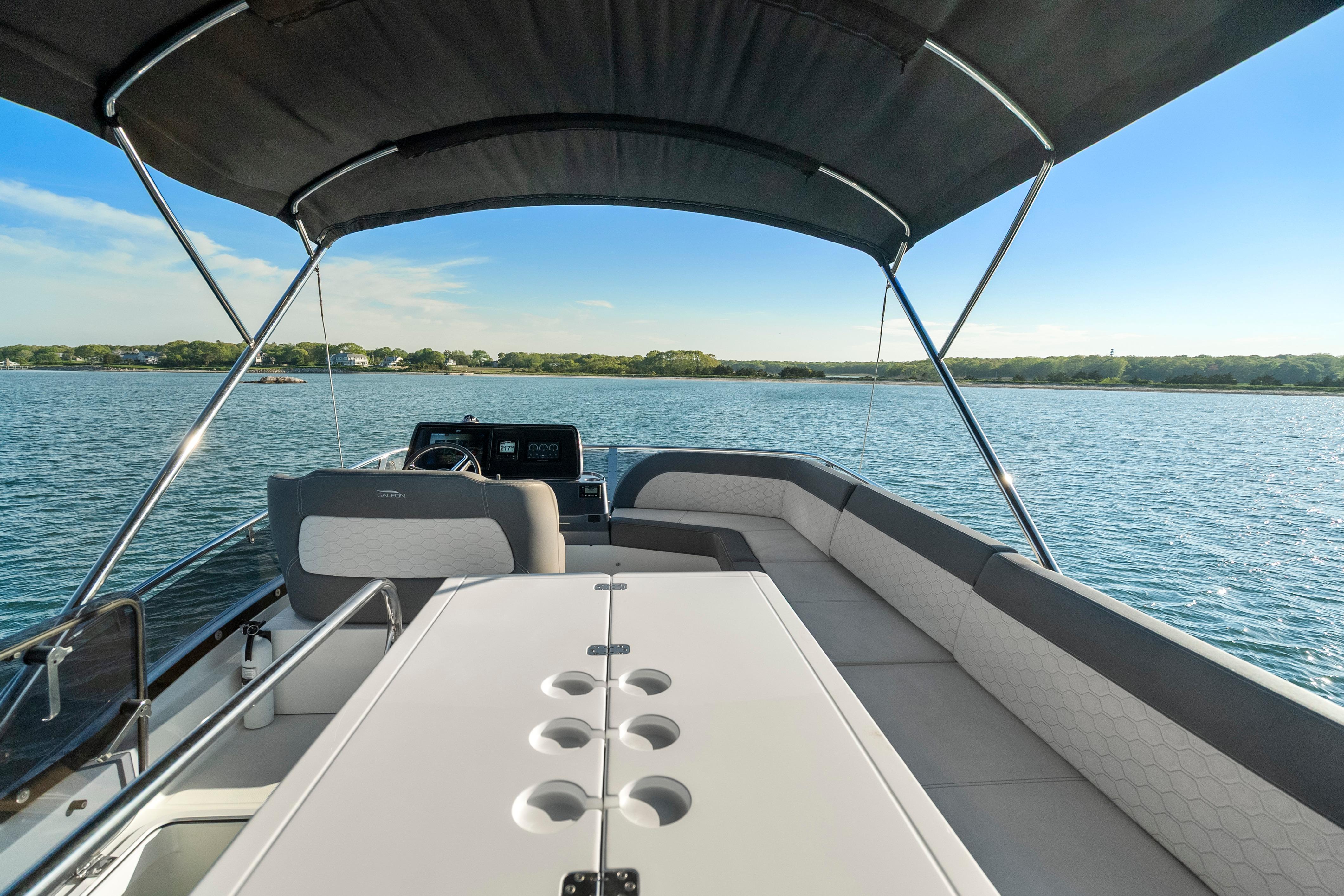 2023 Galeon 400 Fly yacht interior with seating and table on open water.