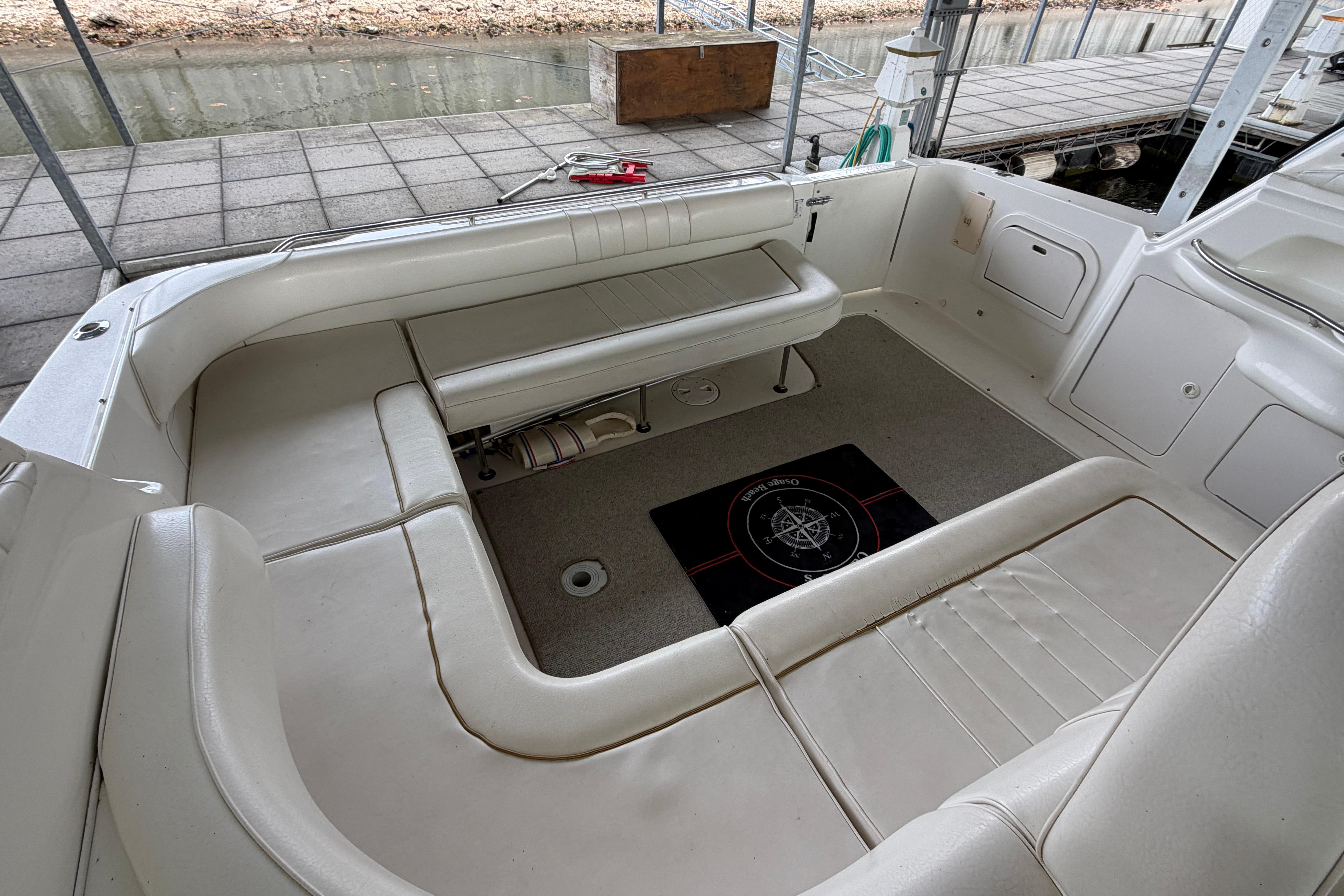 1999 Sea Ray 400 Sundancer boat interior with white seating and carpeted floor.