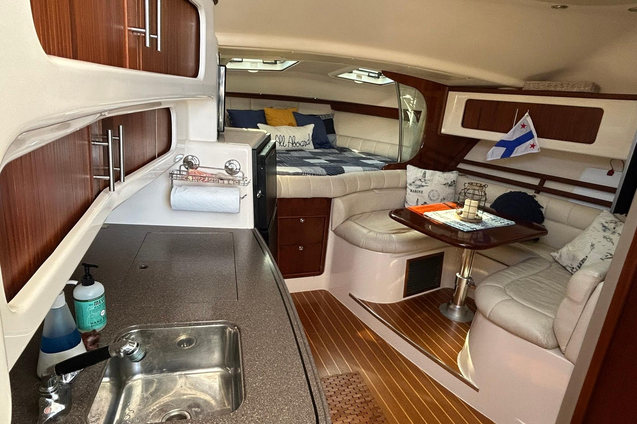 2007 Grady-White Express 360 interior with kitchen, seating, and cozy sleeping area.