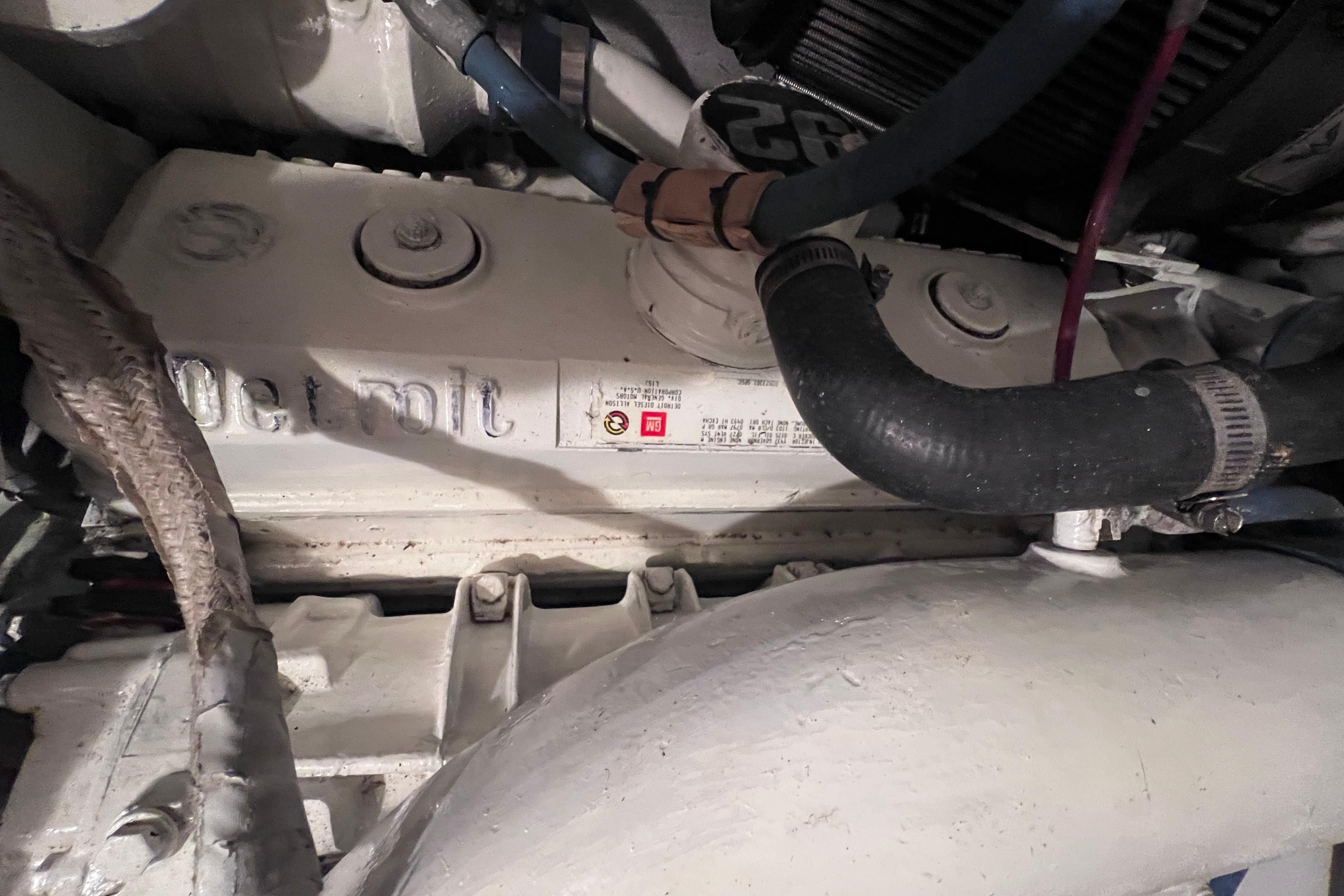 Engine compartment of 1987 Hatteras 70 Cockpit Motor Yacht, featuring Detroit Diesel components.