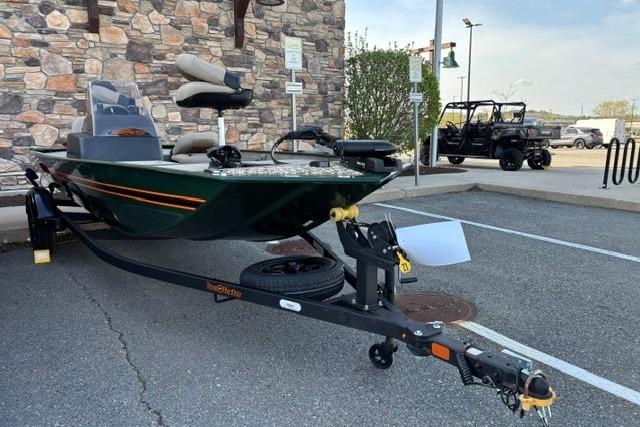 2026 Tracker Bass Tracker Classic Limited boat on trailer in parking lot.