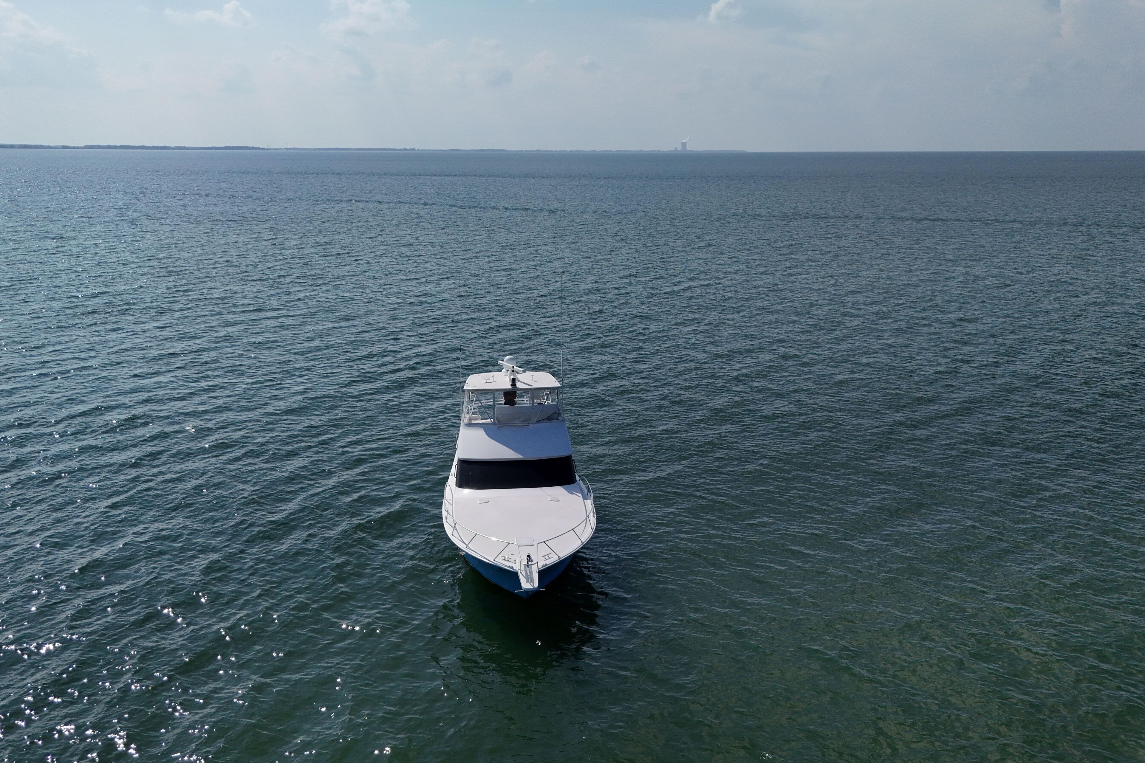 2003 Viking 48 Convertible yacht on open sea under clear sky.