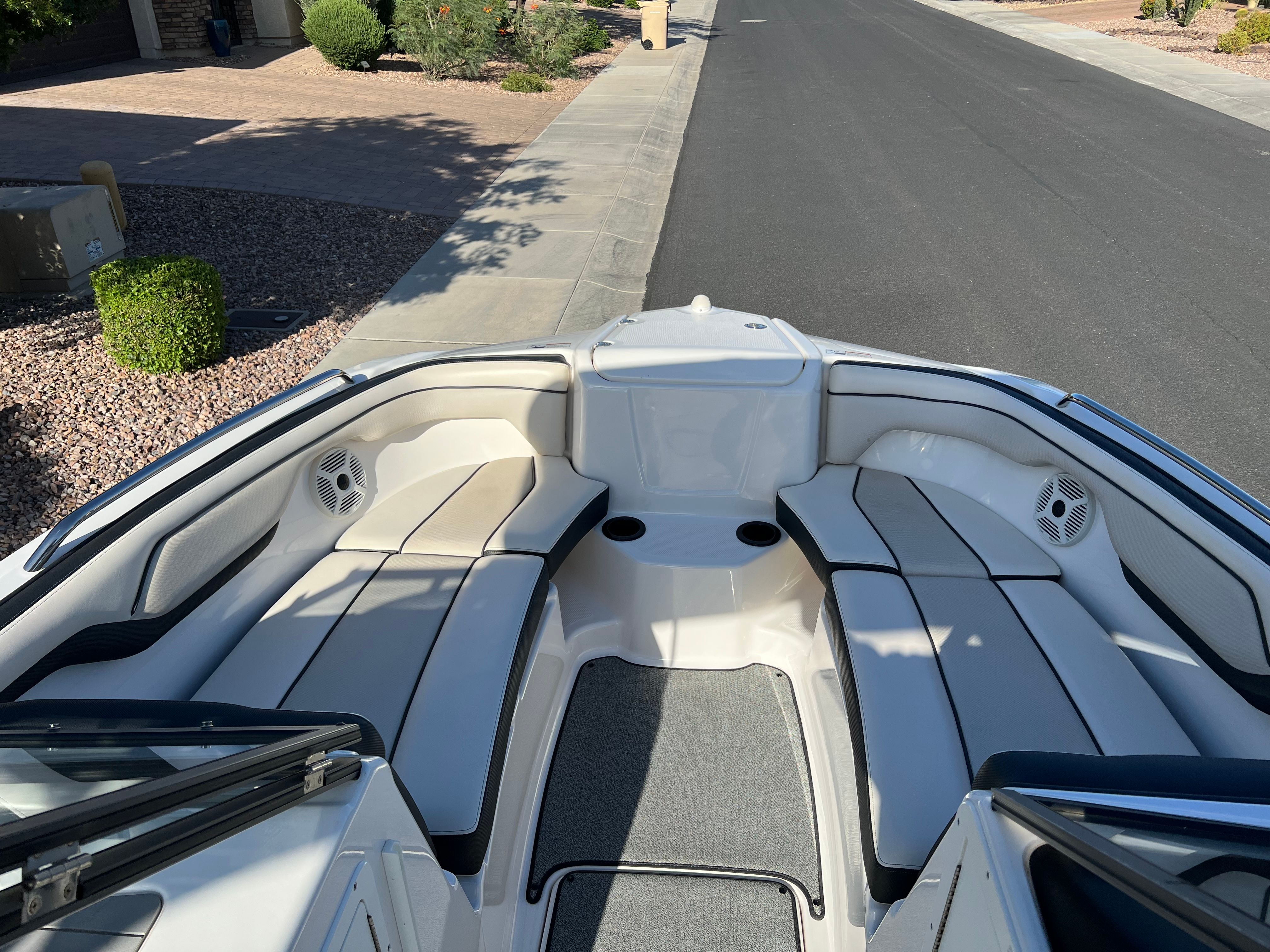 The image shows the bow of a 2018 Yamaha AR210 boat with cushioned seats and speakers.