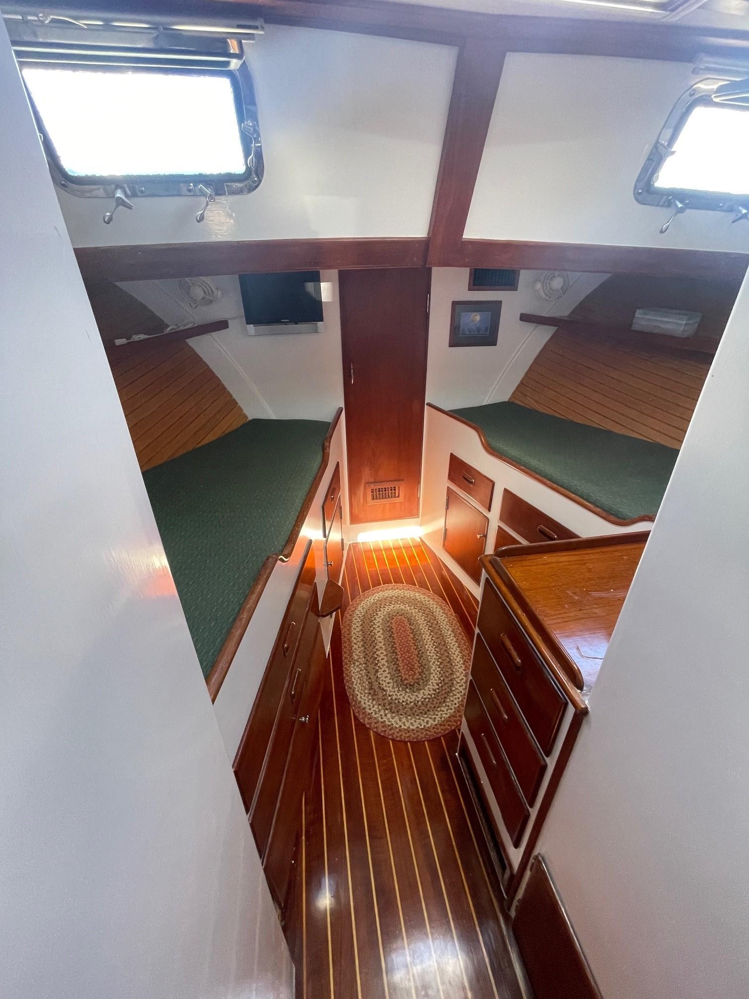 1979 Jarvis Newman Trawler cabin interior with twin beds and wooden flooring.
