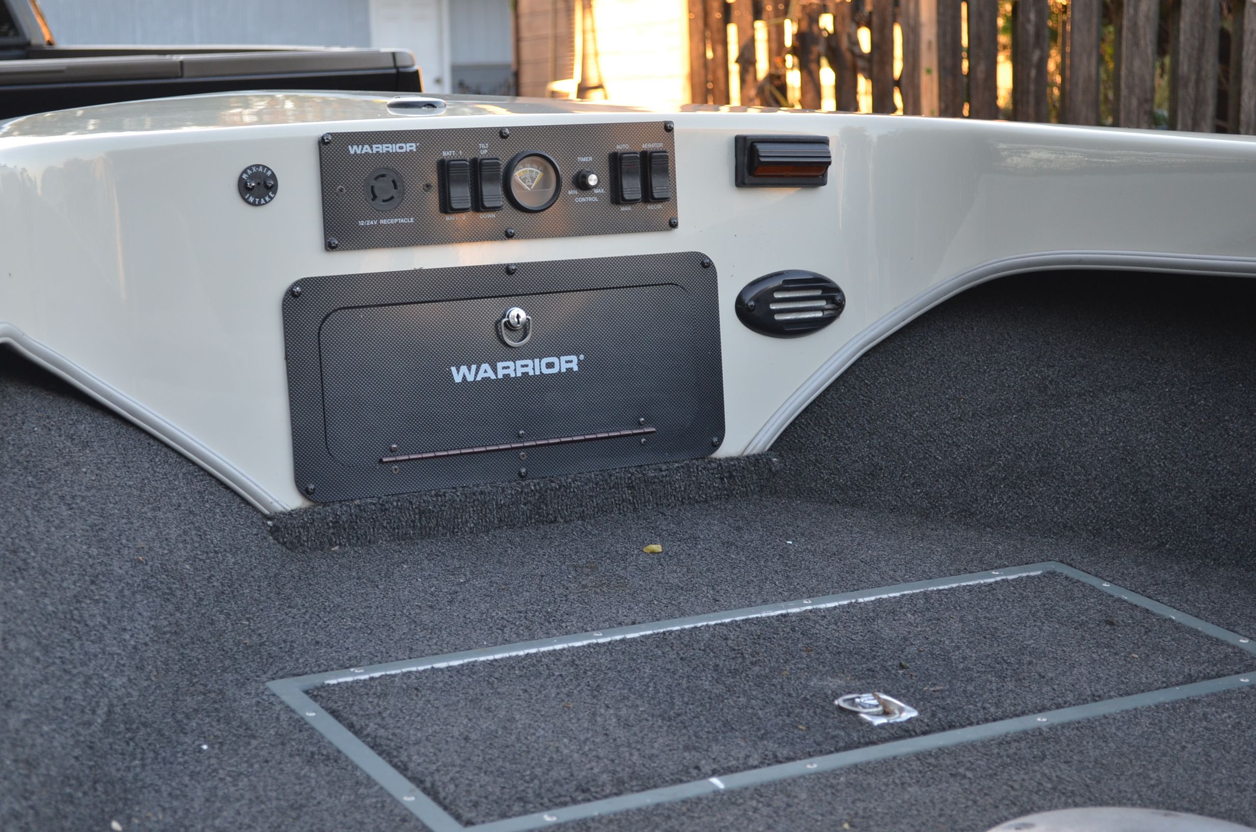 The image shows the cockpit of a 2000 Warrior V1890 Backtroller Eagle with gray carpet flooring.