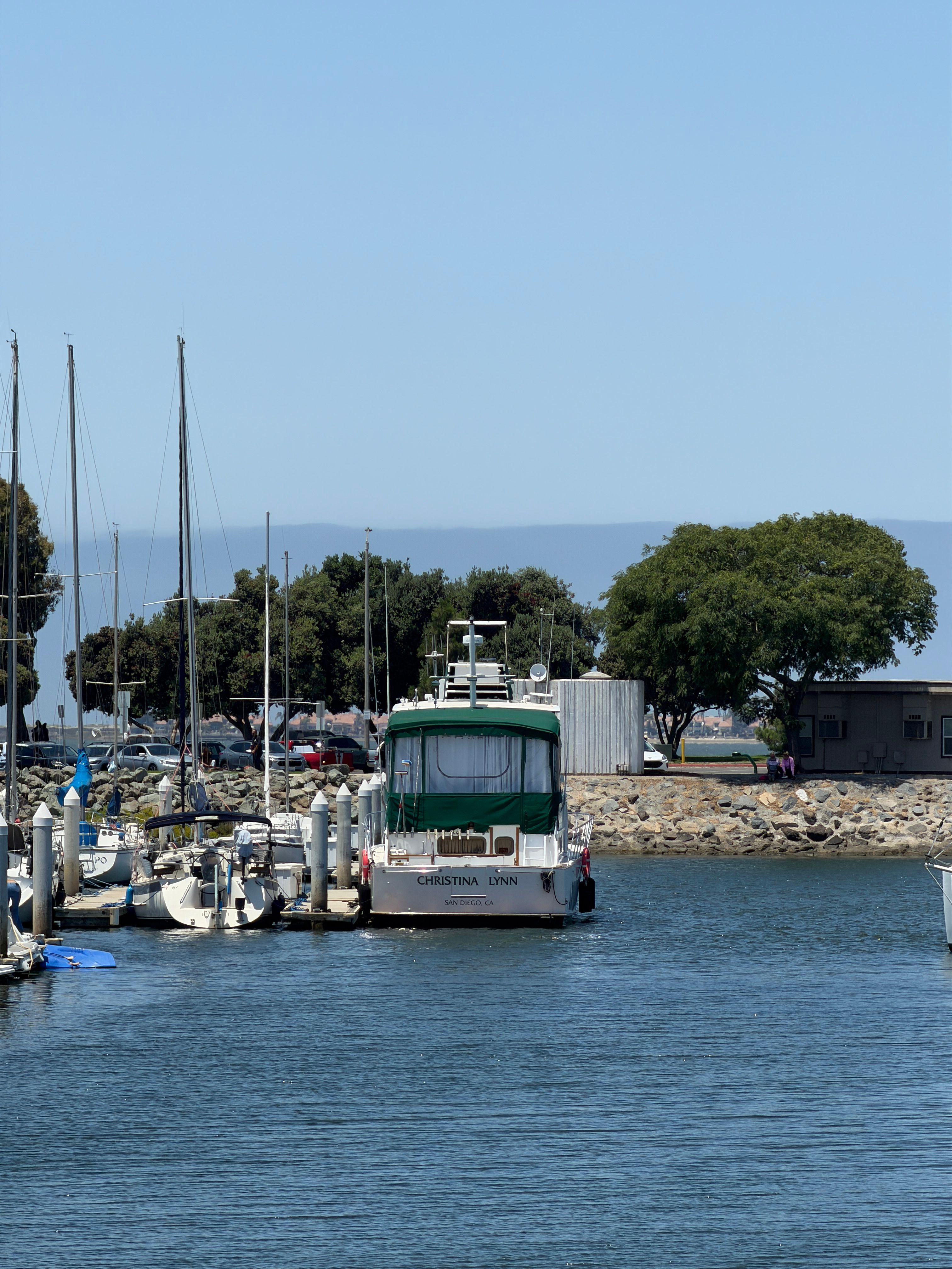 1966 Drake Yachtfisher docked in marina, surrounded by sailboats.