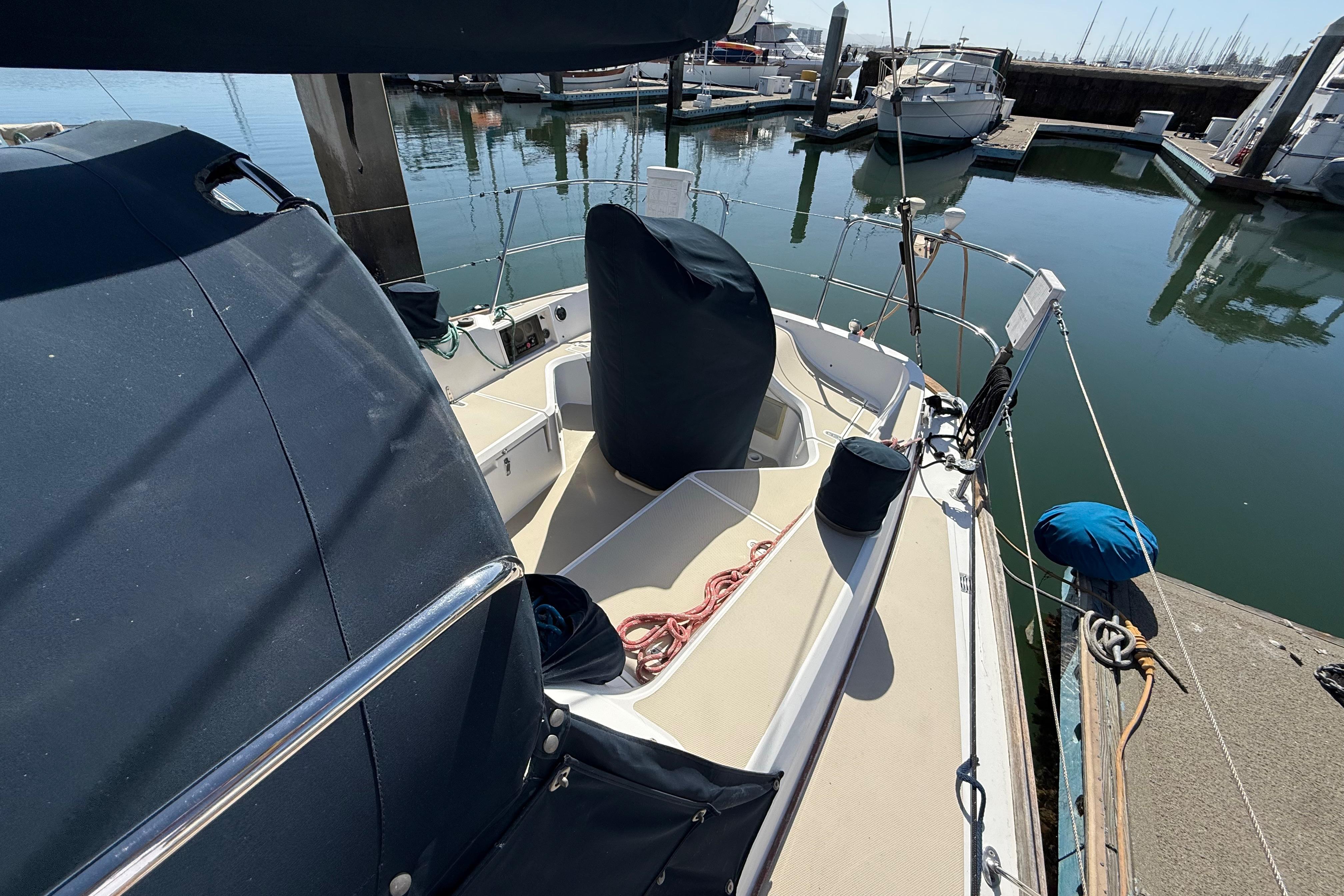 2004 Sabre 386 sailboat docked at marina, featuring covered cockpit and nautical equipment.