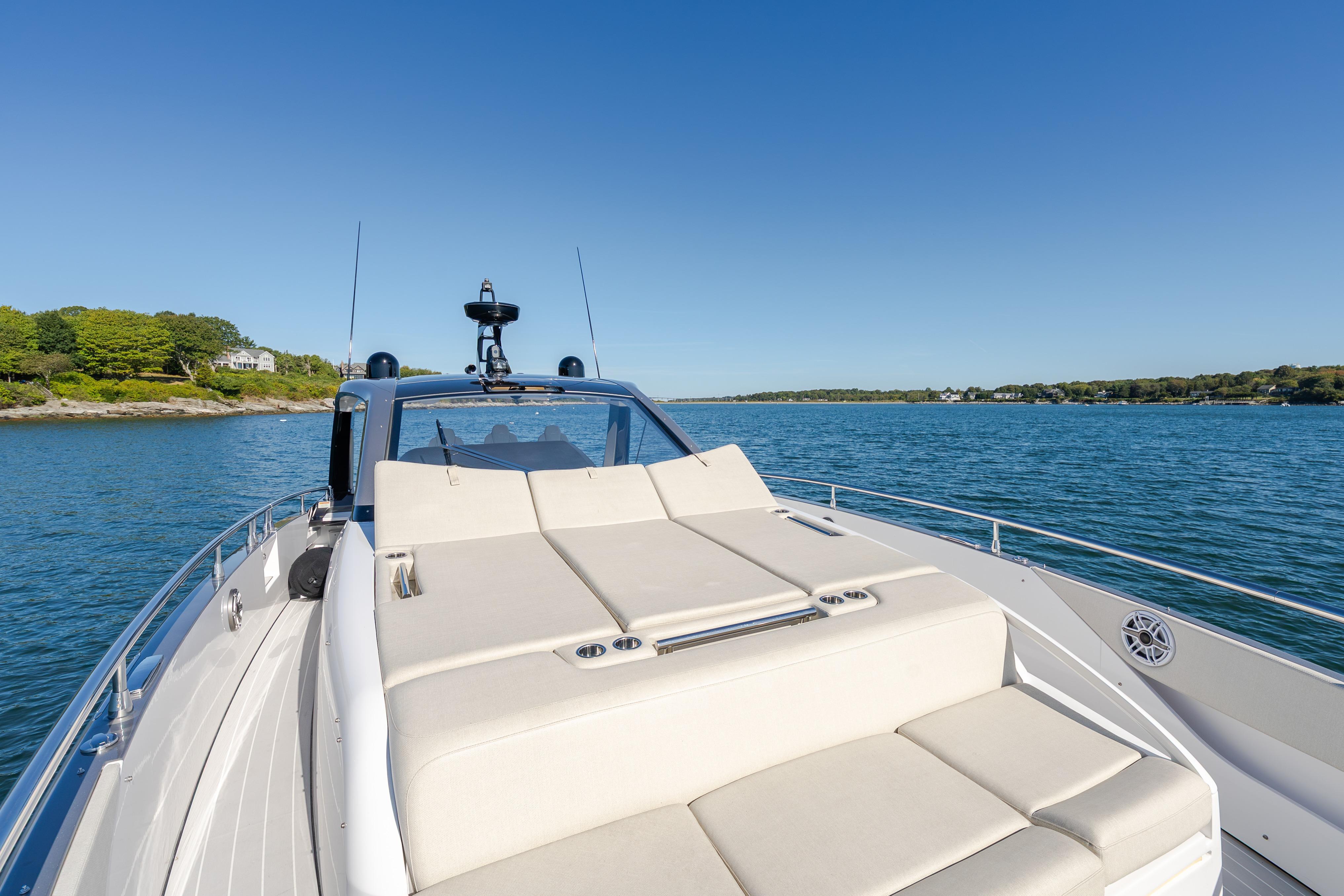 2023 Azimut Verve 47 yacht cruising on serene waters under clear blue skies.