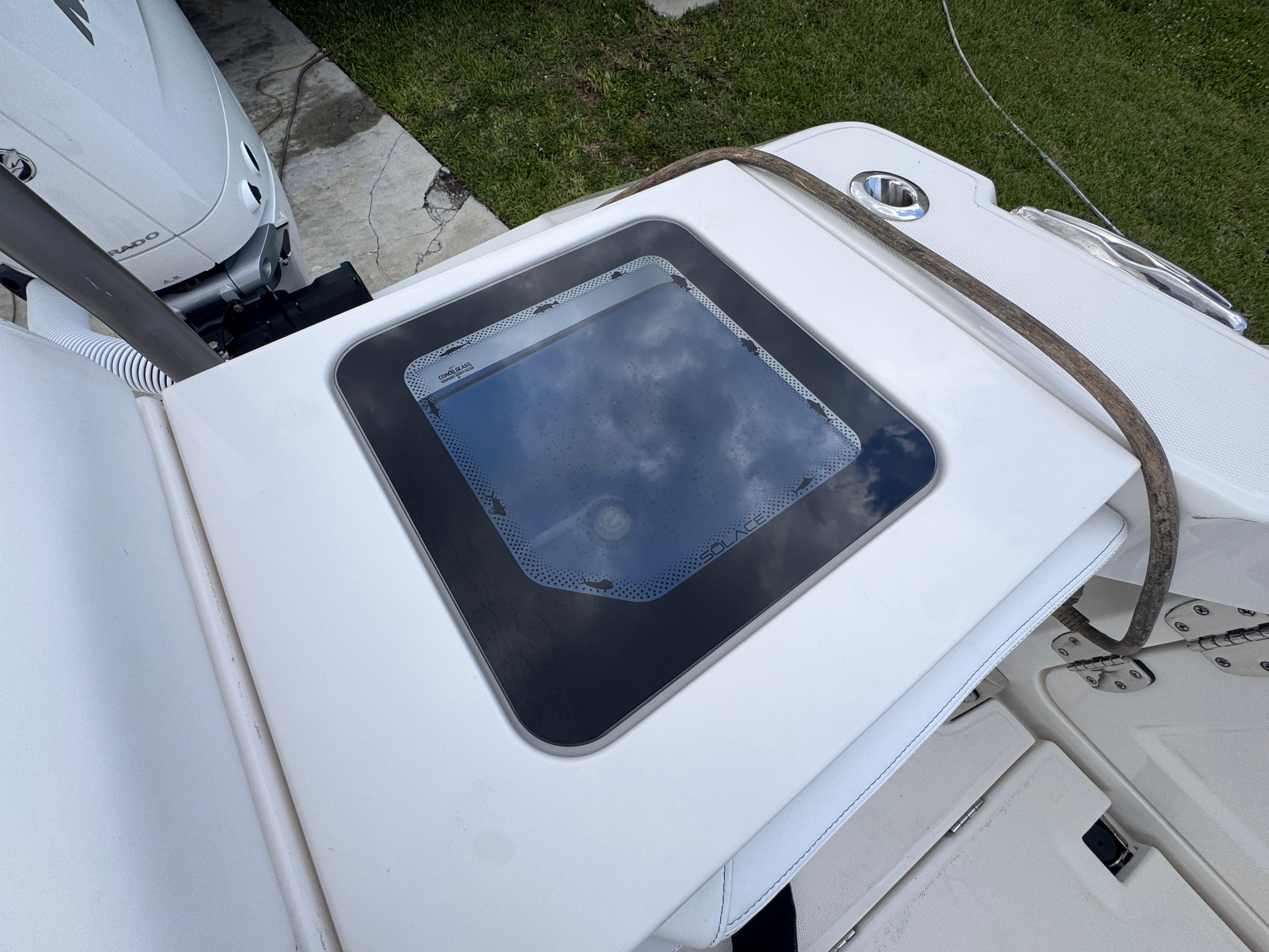 2025 Solace 32 CS boat deck with a glass hatch and strap.