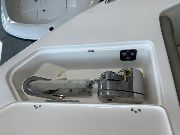 2024 Key West 263 FS boat anchor compartment with stainless steel anchor and winch.