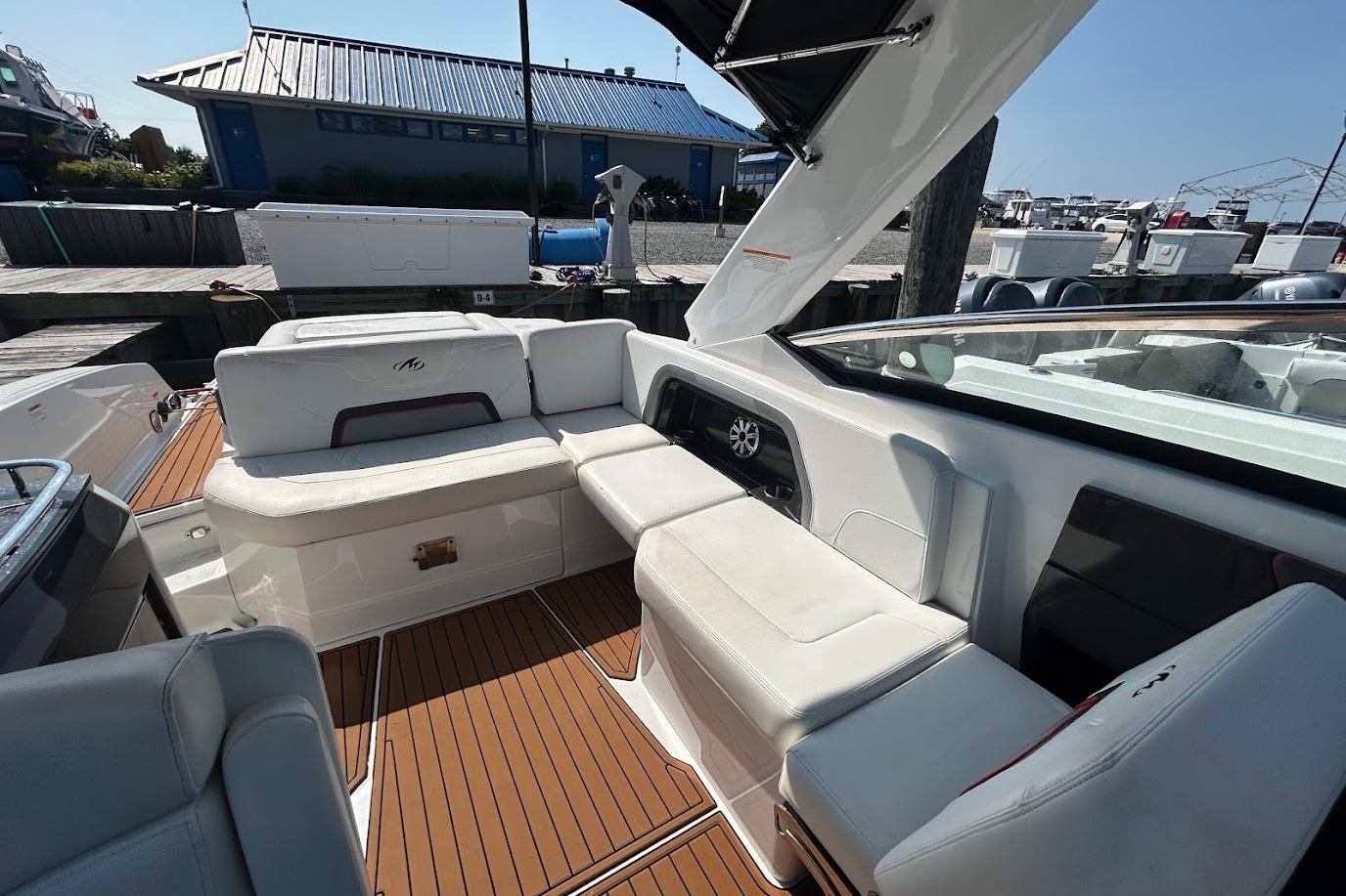 2015 Monterey 288 Super Sport boat interior with white seating and wood flooring.