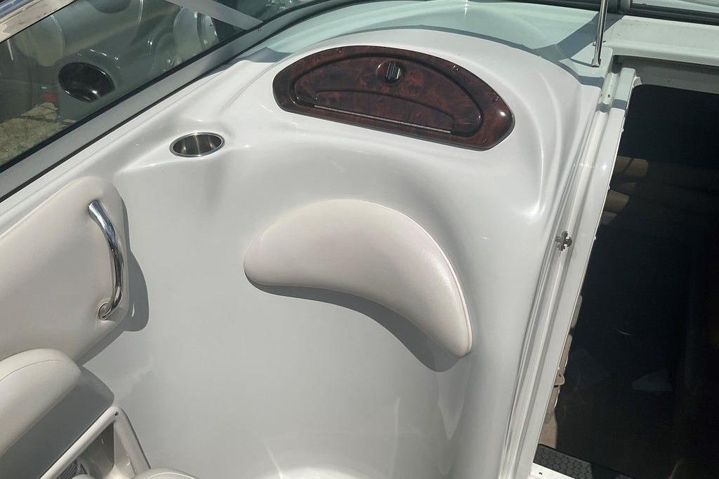 Interior of 2015 Crownline 236 SC boat, featuring sleek white design and cup holder.