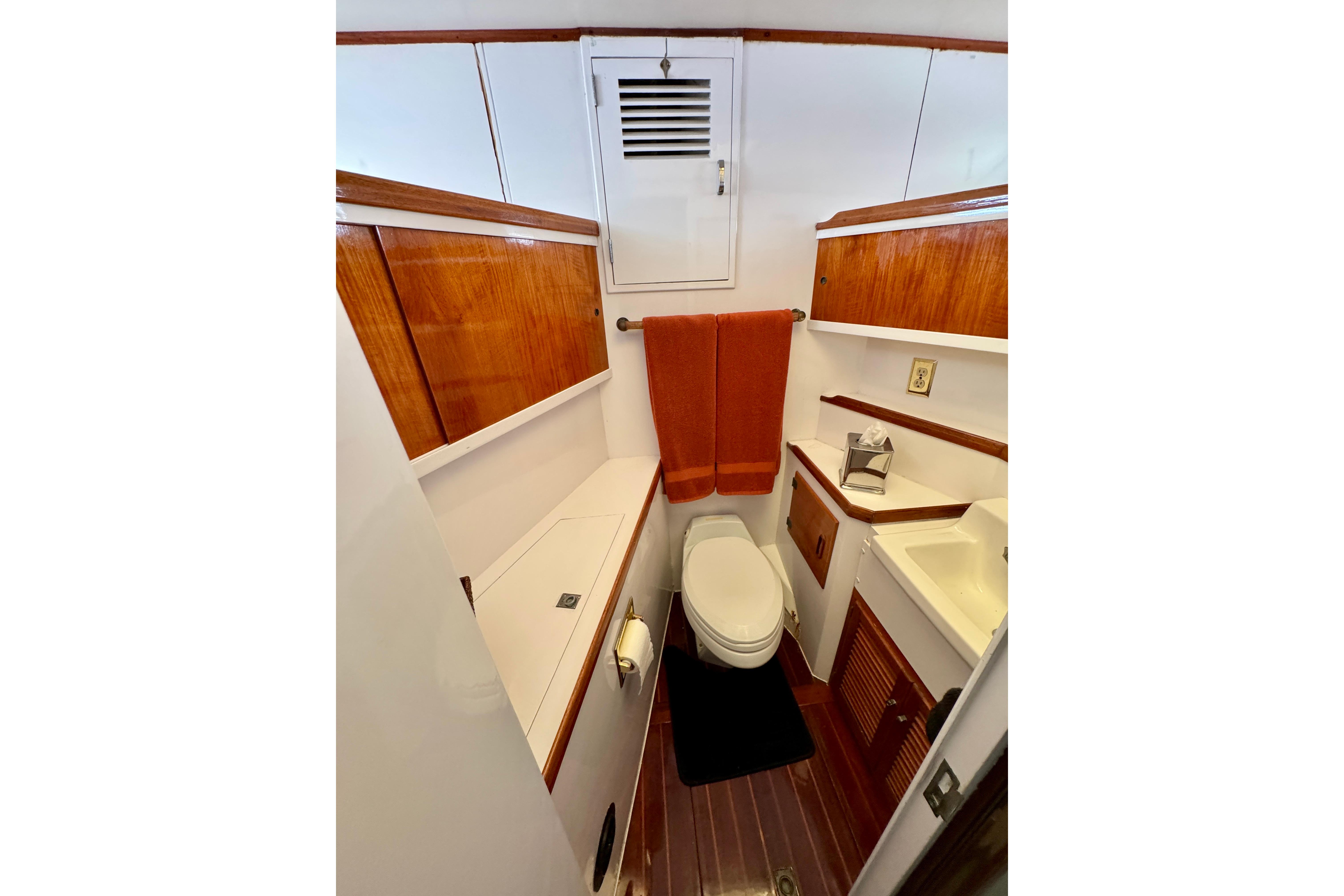 1958 Blanchard Pilothouse bathroom with wooden cabinetry and modern fixtures.